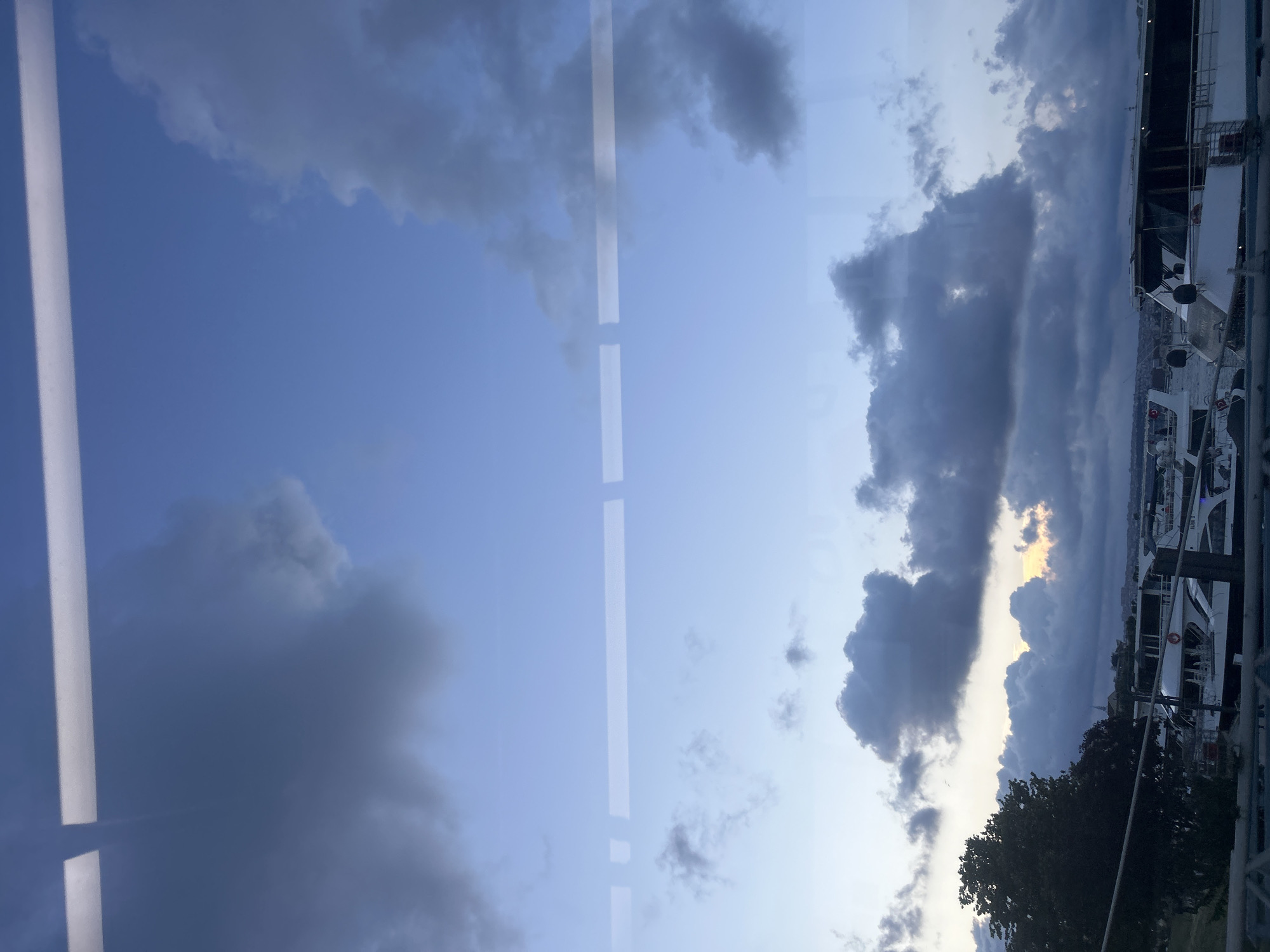 Evening pedestrians cross Bosphorus bridge under dramatic cloudy Istanbul sky