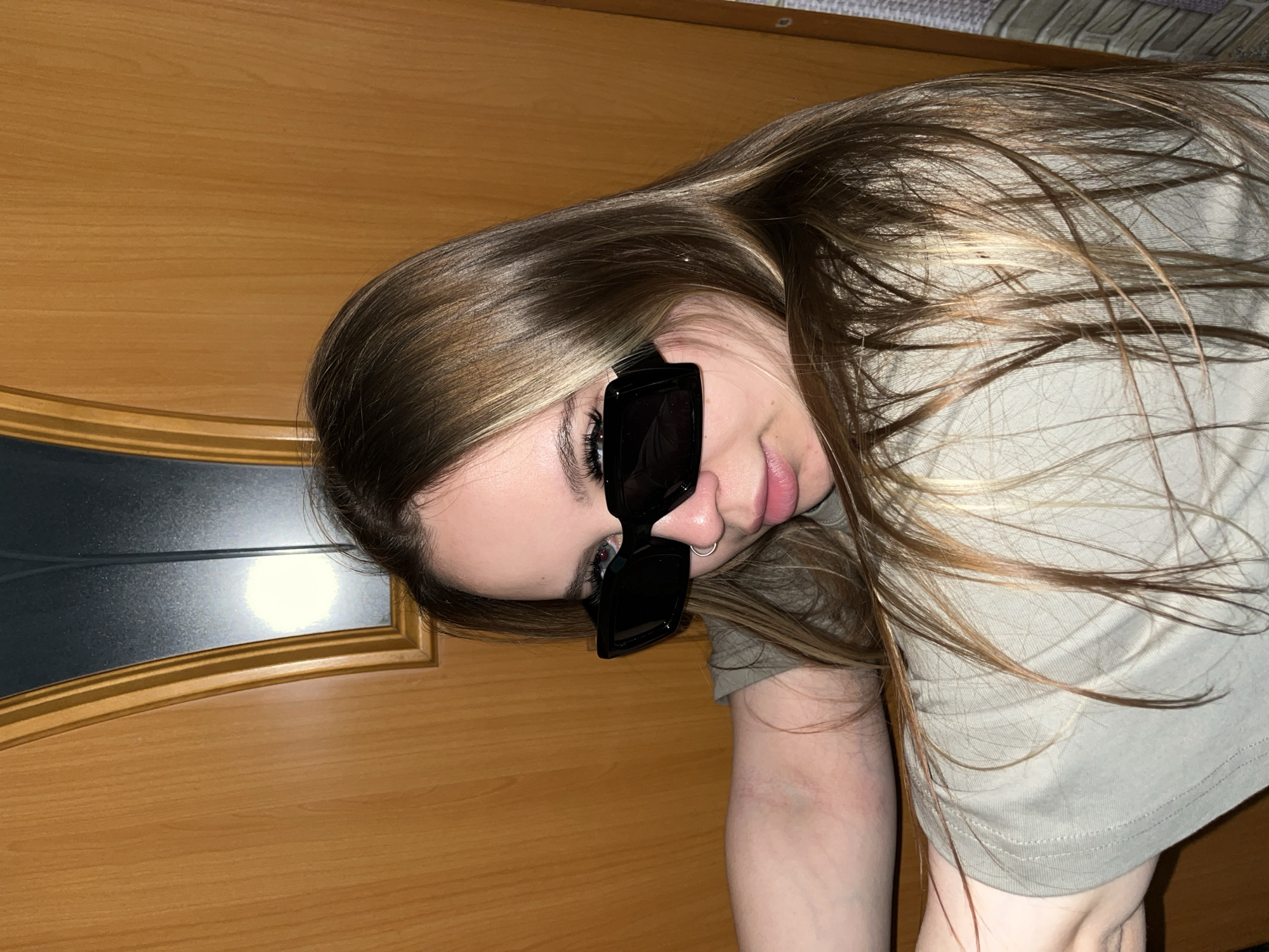 Young woman photographed in casual indoor poses in Port-Katon