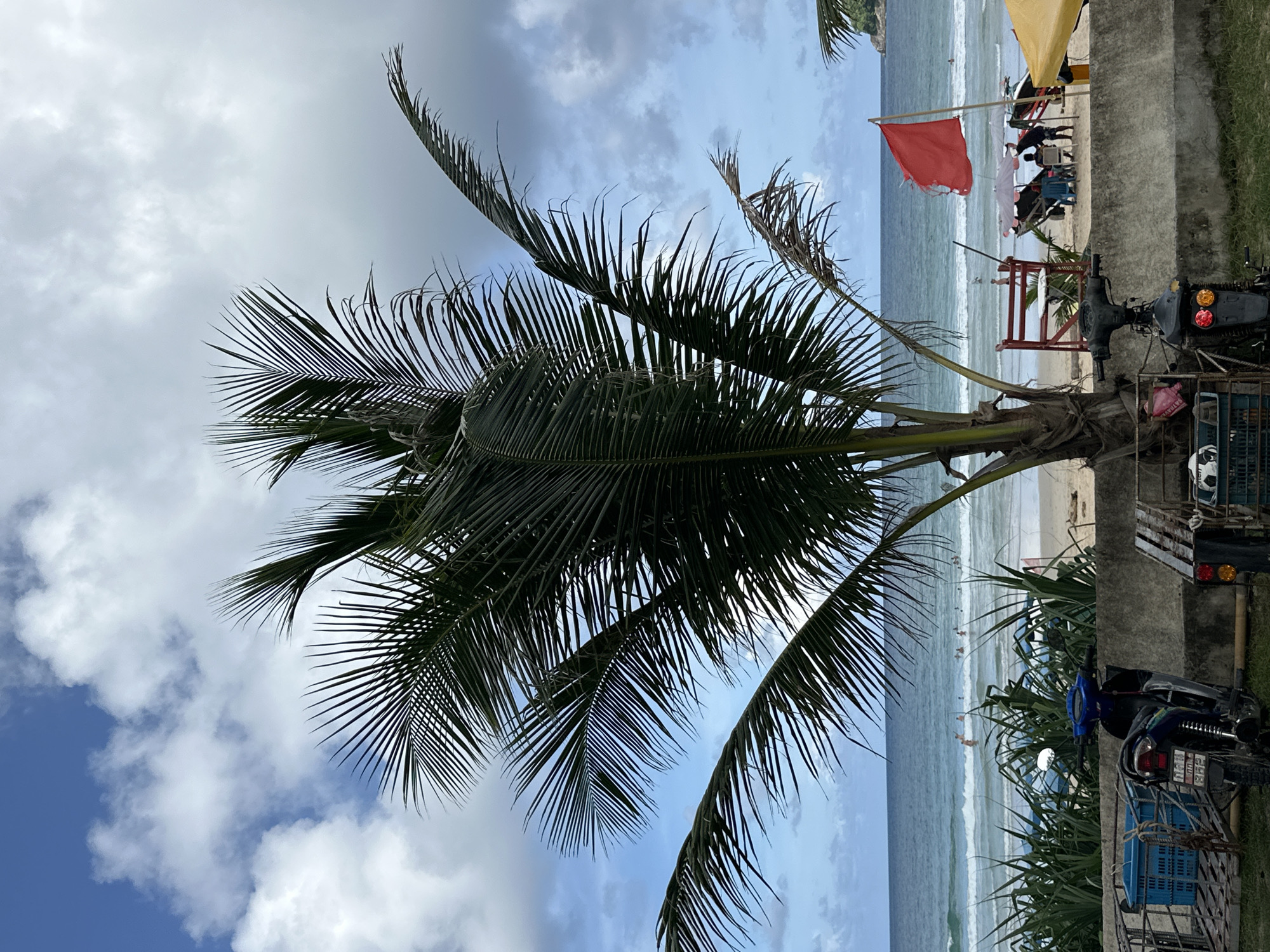 Karon Beach on a cloudy afternoon, surf gear and street life