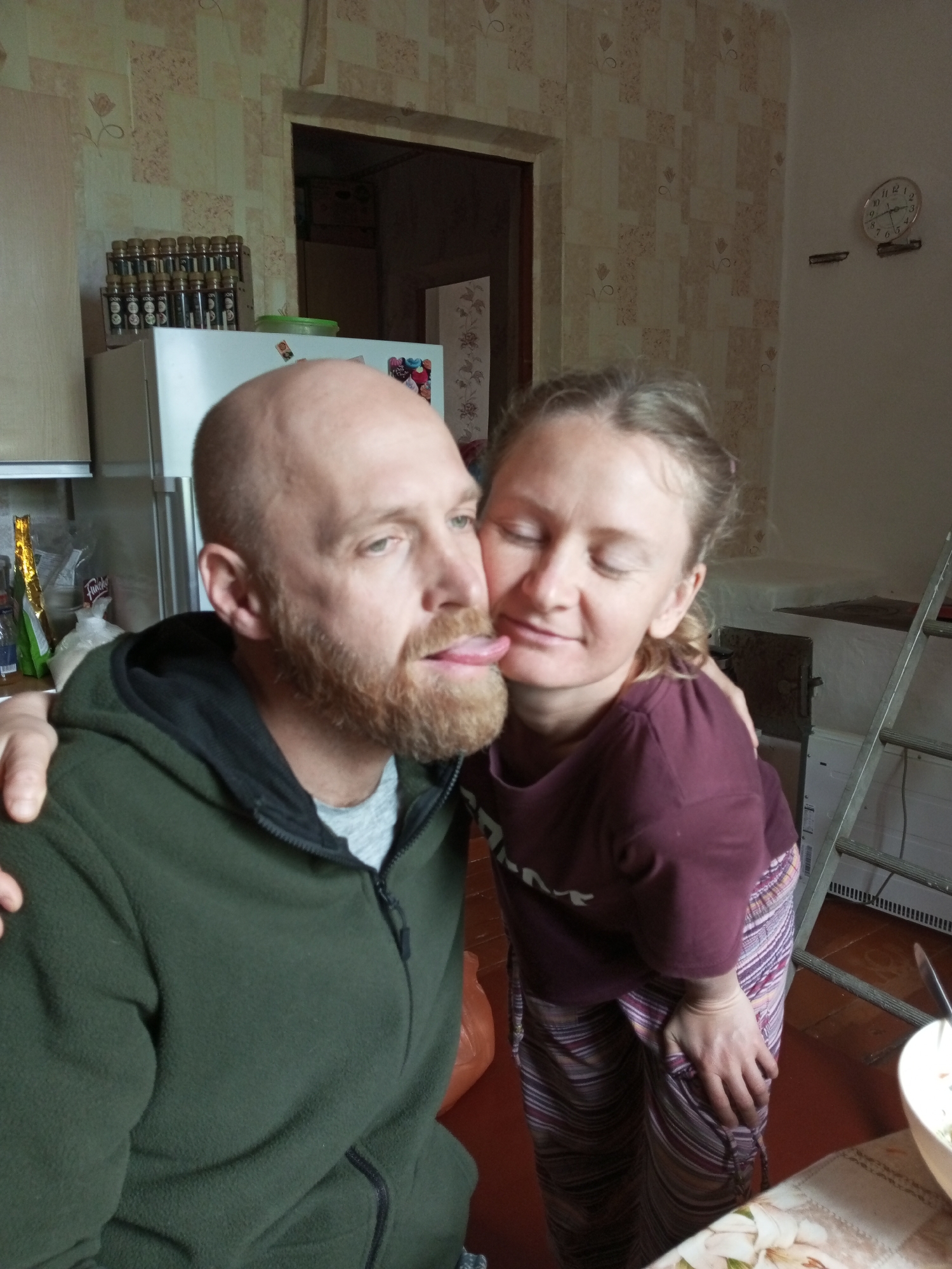 Couple shares meal preparation moment in Ukrainian village kitchen