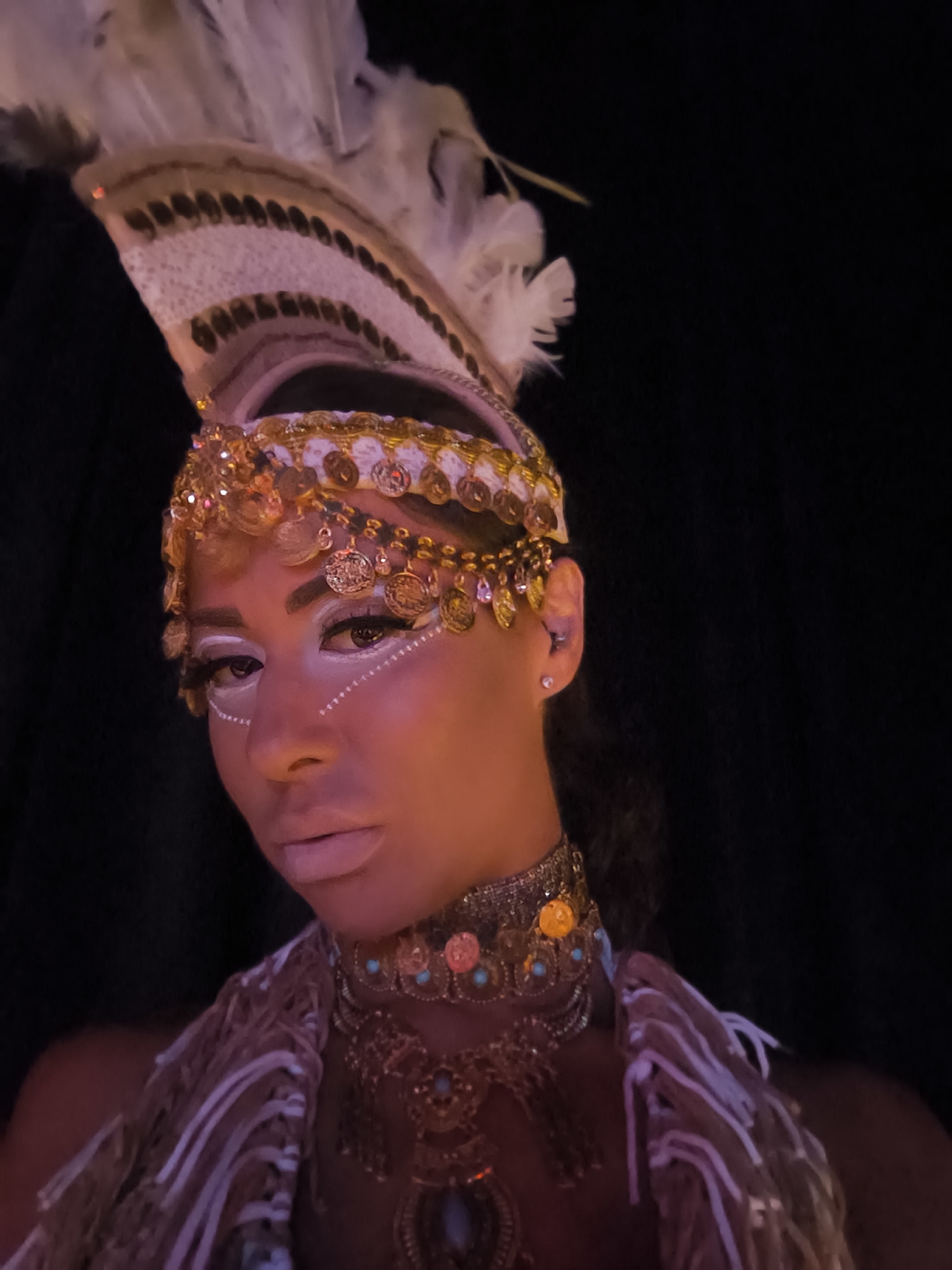Elaborately costumed performer on stage at packed Kassandra nightclub