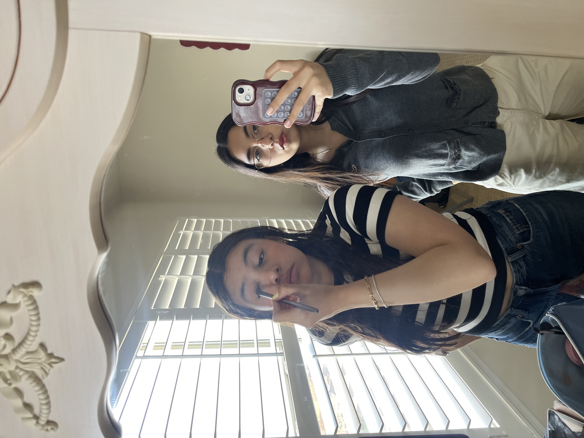 Women share mirror moment during makeup routine in San Antonio