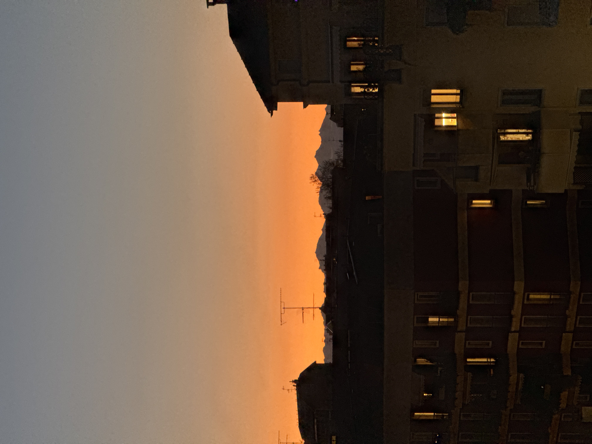 Milan skyline captured at twilight with orange horizon gradient