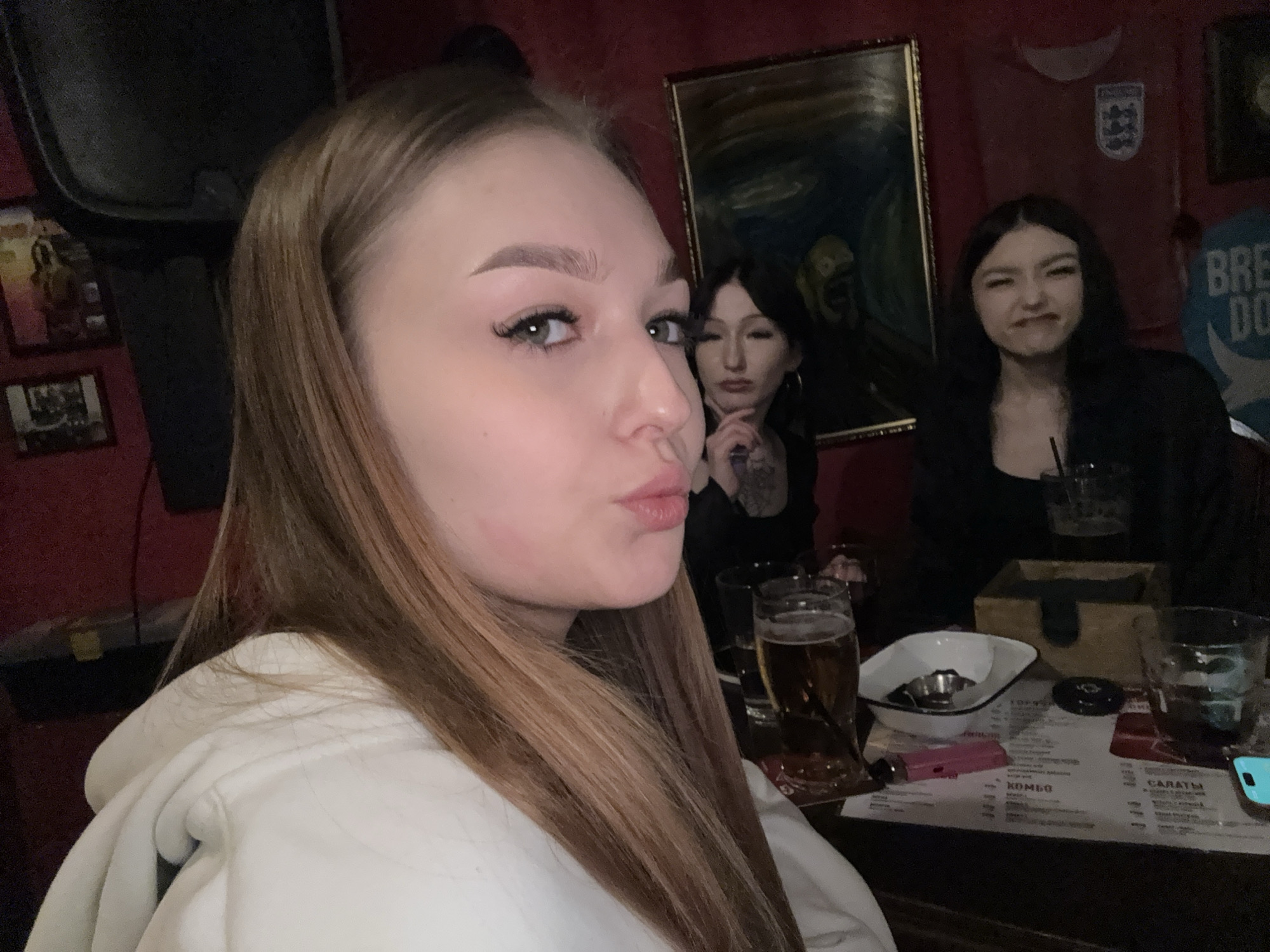 Friends gather at Chaikovsky pub during rainy April evening