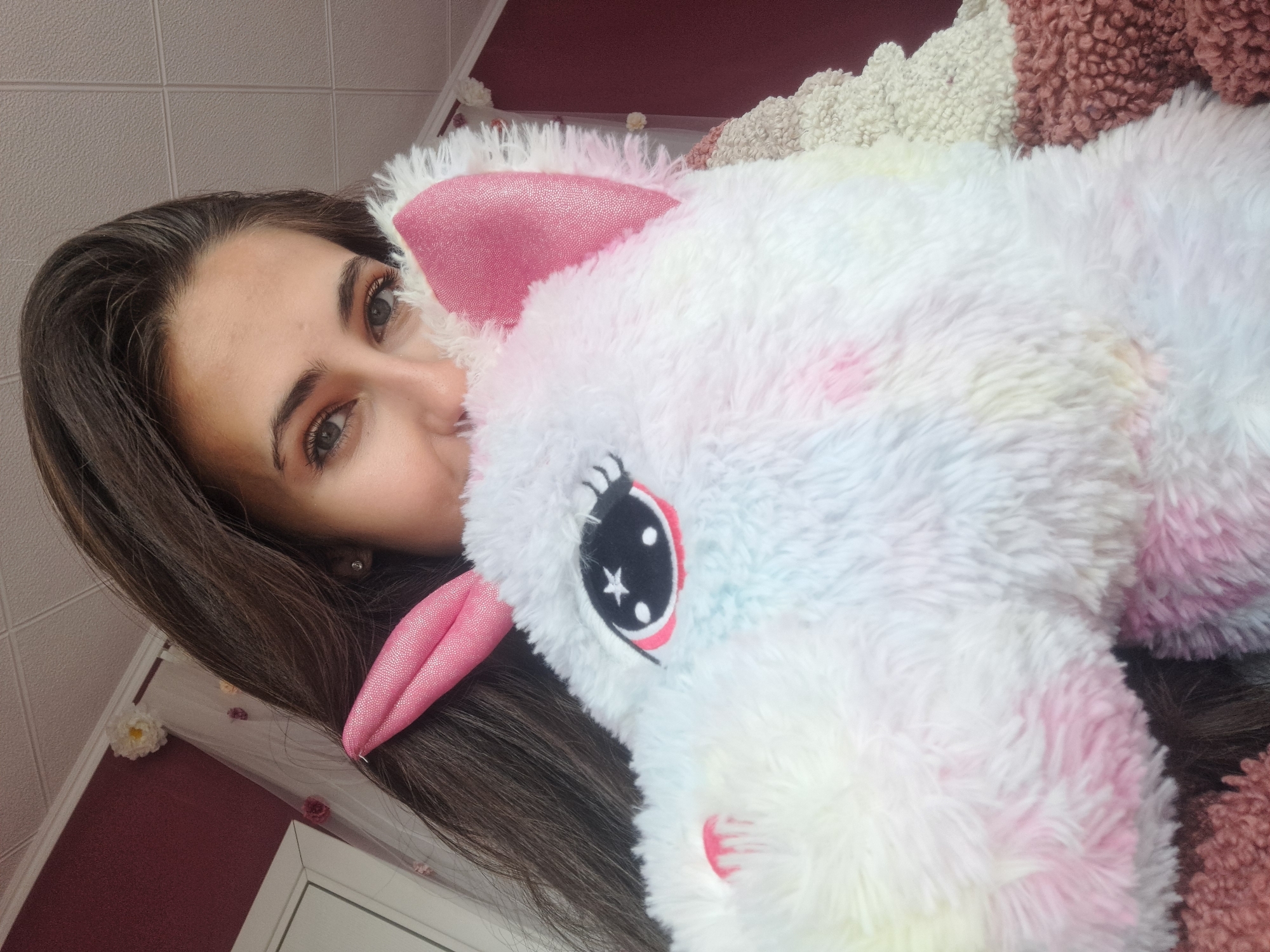 Woman holds stuffed unicorn in Bulgarian home