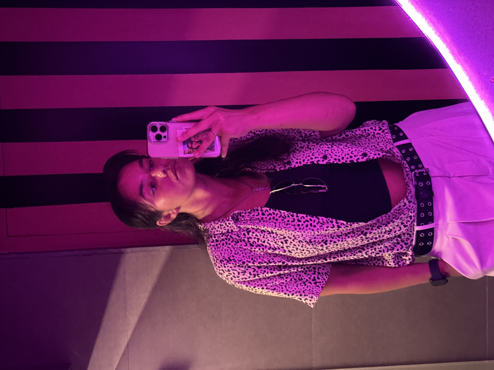 Mirror selfie captured with purple neon lighting in Arpora
