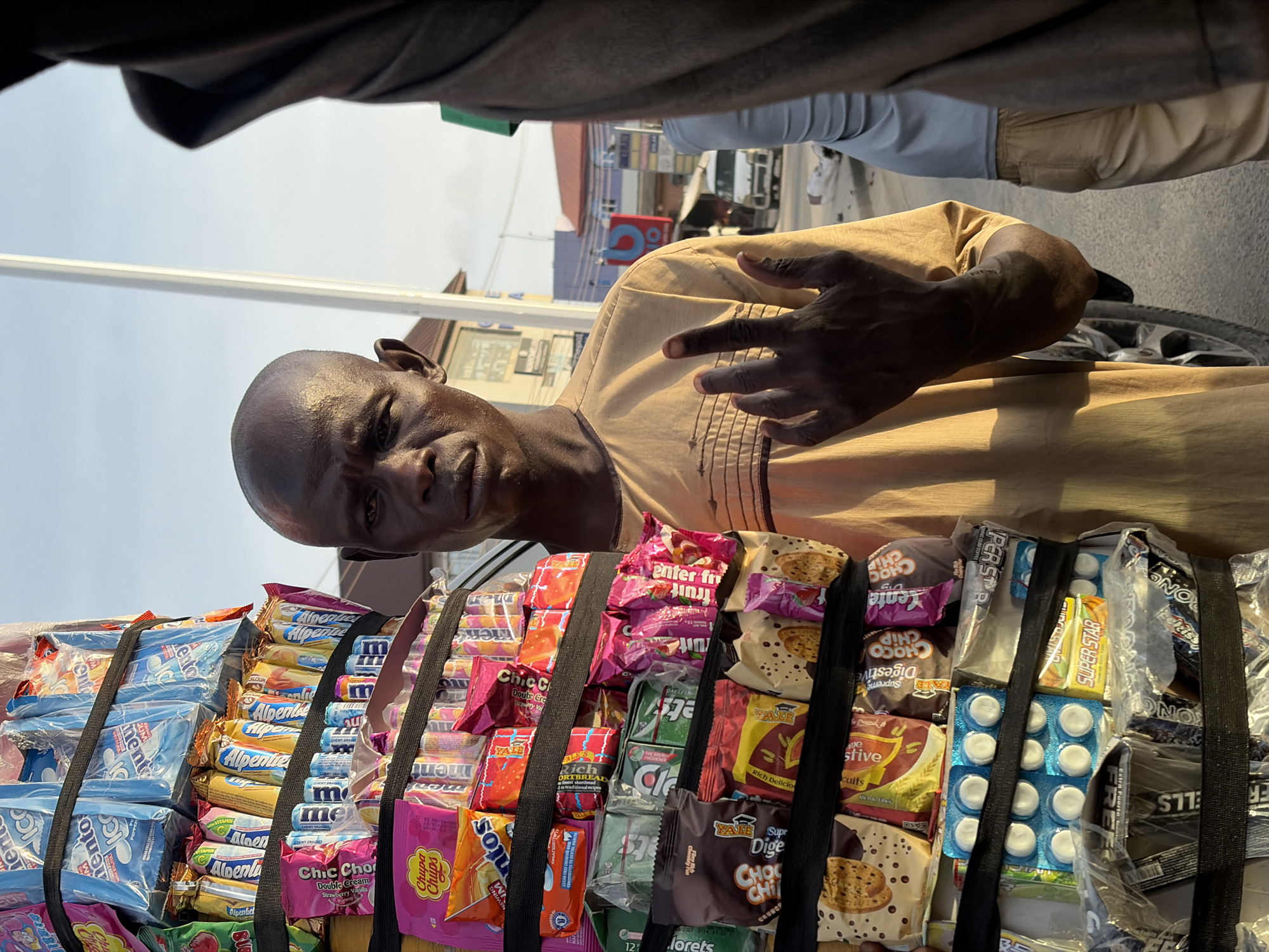 Mobile vendor sells candy, snacks on streets in Ado, Nigeria