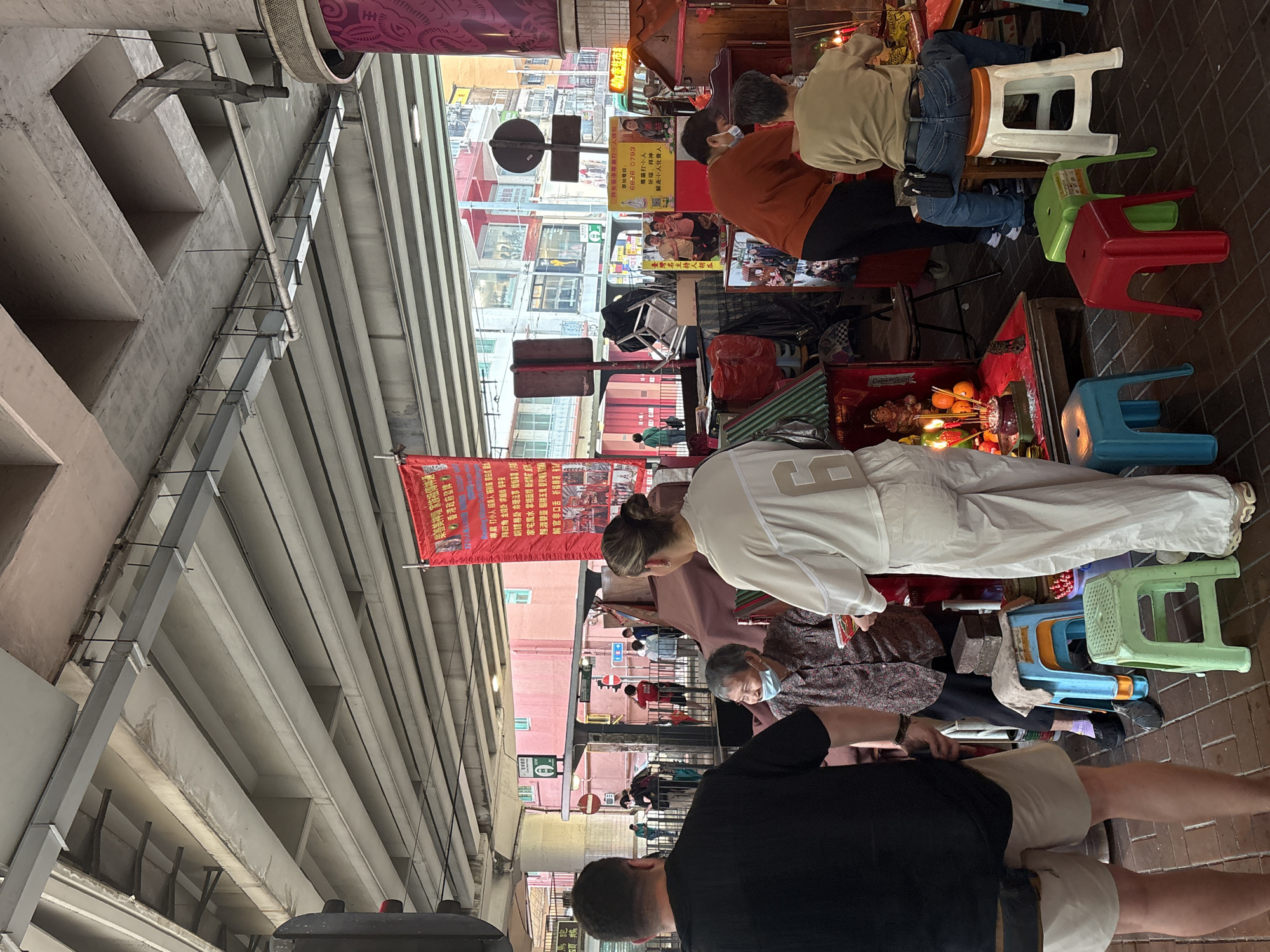 Early morning ritual observed at Hong Kong street shrine