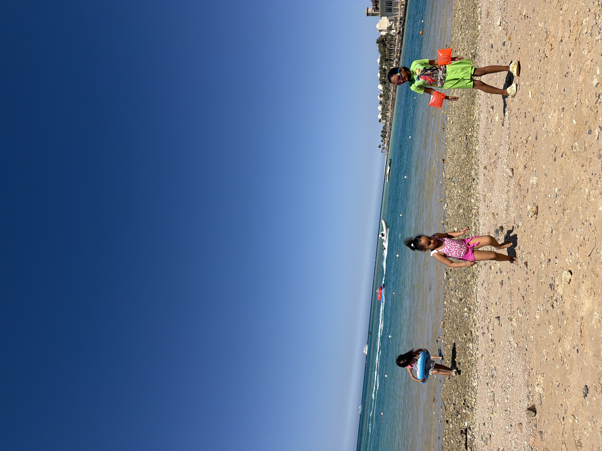 Children enjoy sunny beach day in Hurghada, Egypt