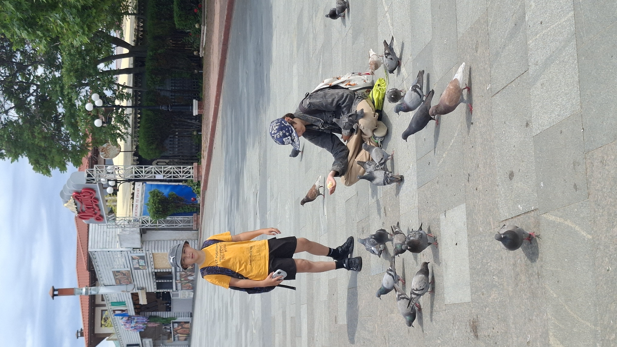 Morning outdoor activities: pigeon feeding and beachside relaxation documented