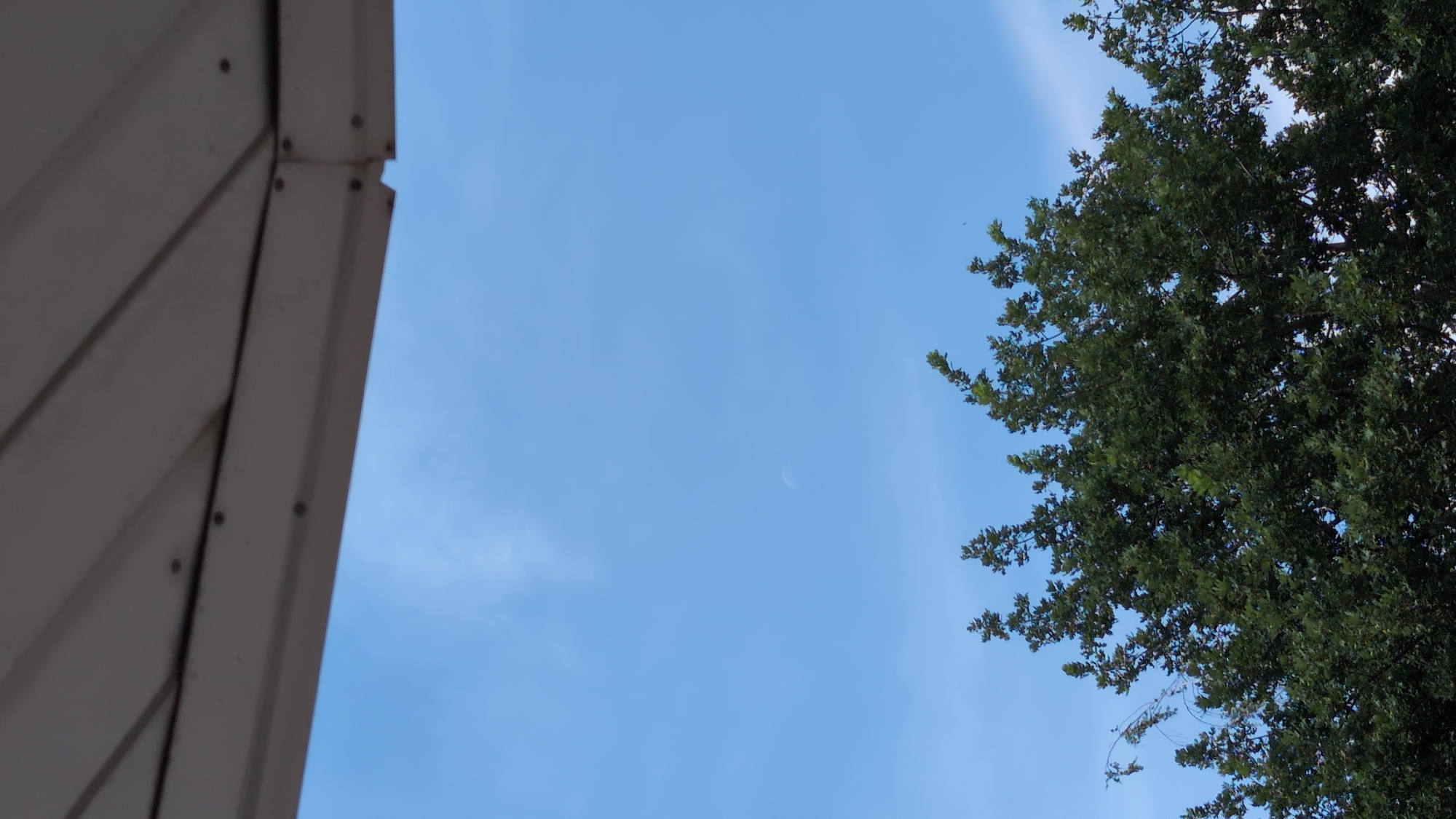 White corrugated overhang meets clear blue sky in Mykolaiv