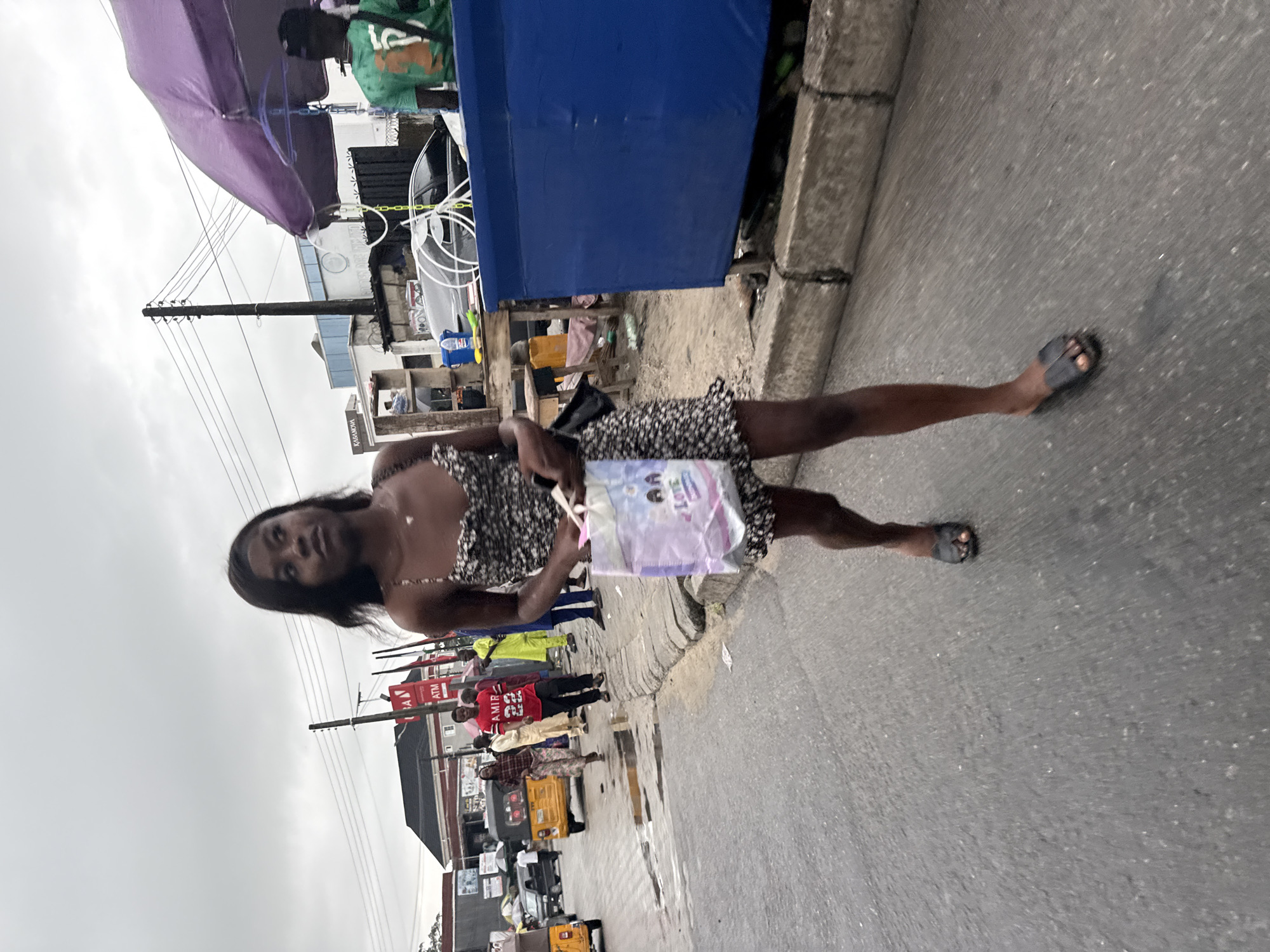 Everyday street life captured in Ado, Nigeria under overcast skies