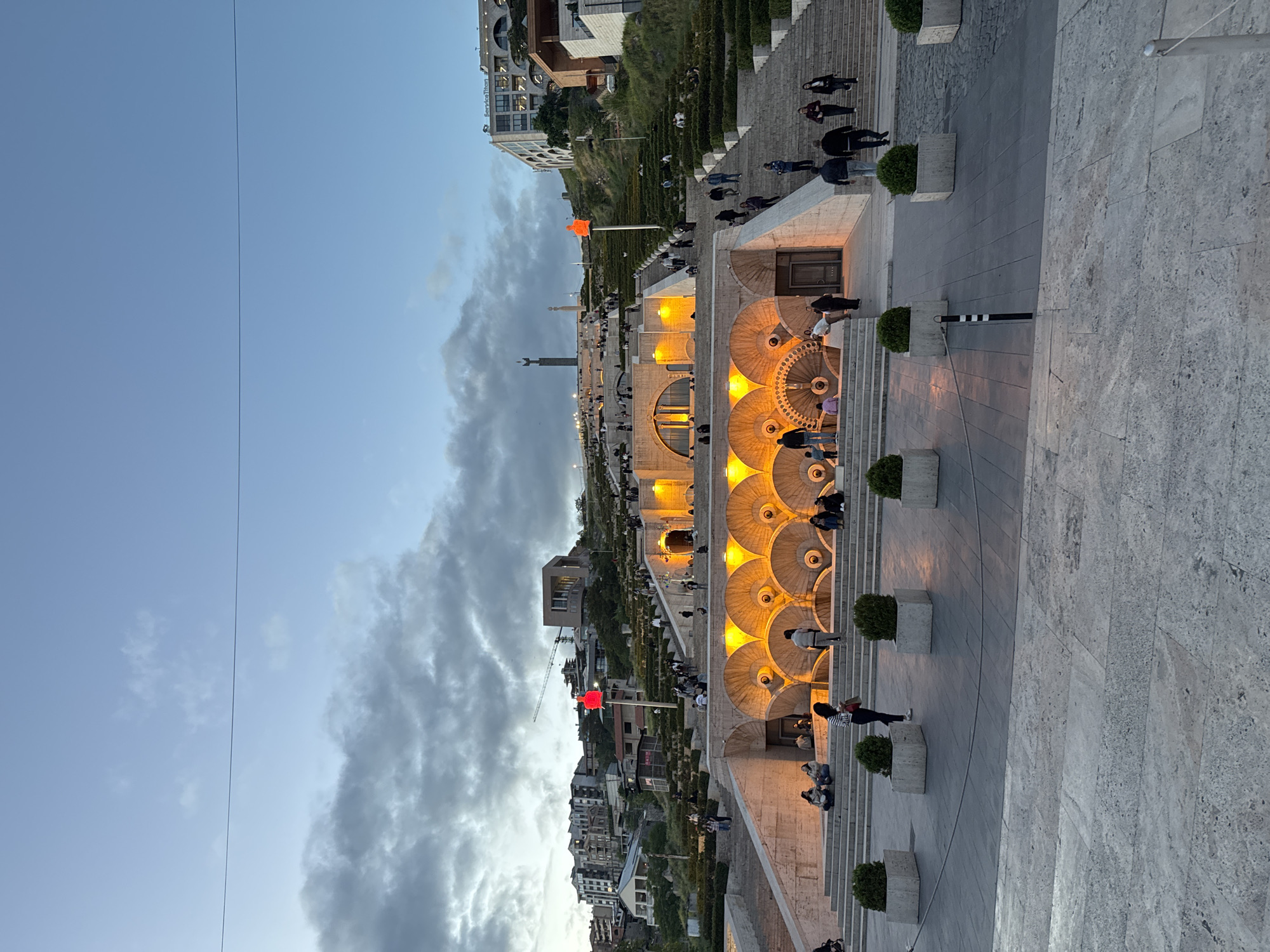 Evening visitors gather at illuminated Yerevan Cascade complex