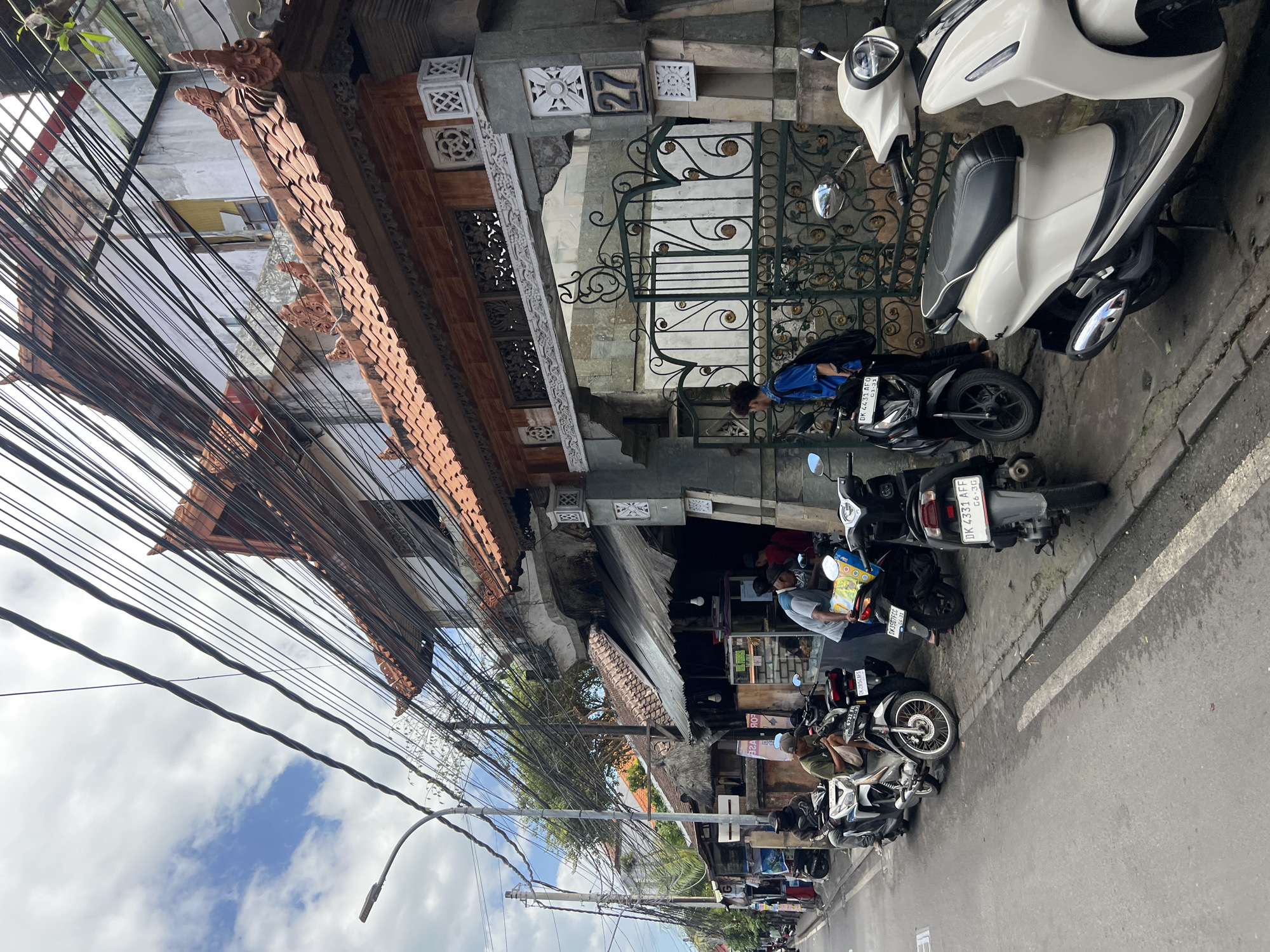 Street life and architecture along a busy Kuta road