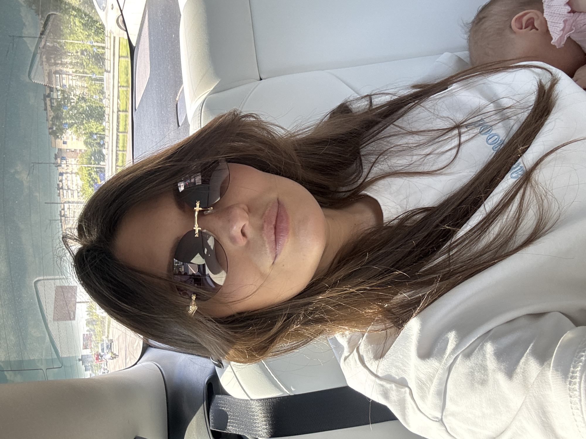 Woman and baby spotted in car during sunny day in Kyiv