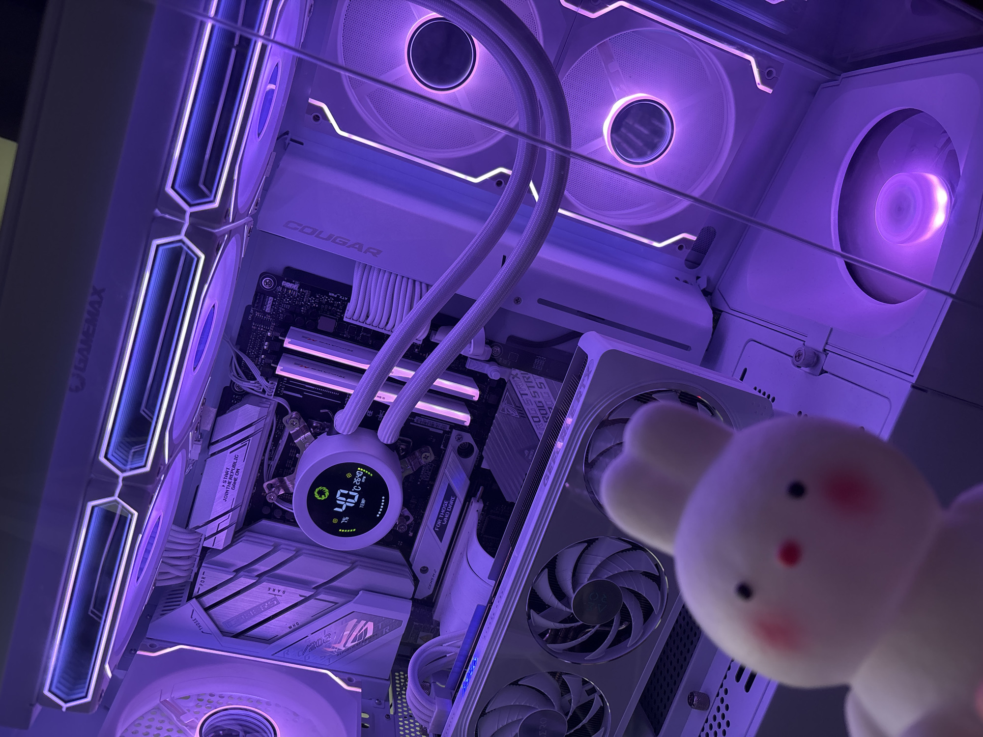 Purple-lit gaming PC paired with collectibles and outdoor scenery