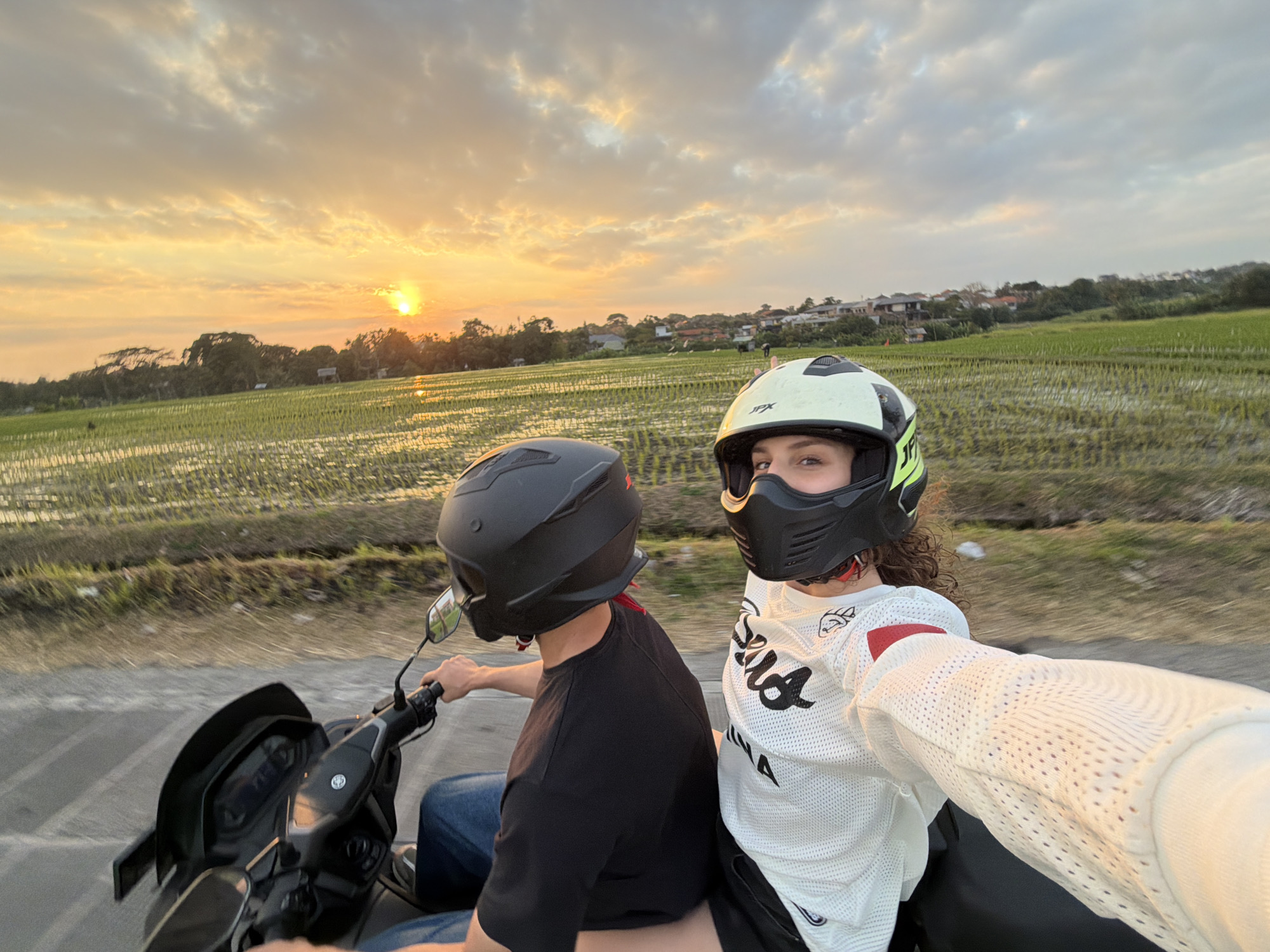 Motorcycle riders film sunset selfies in North Kuta Indonesia