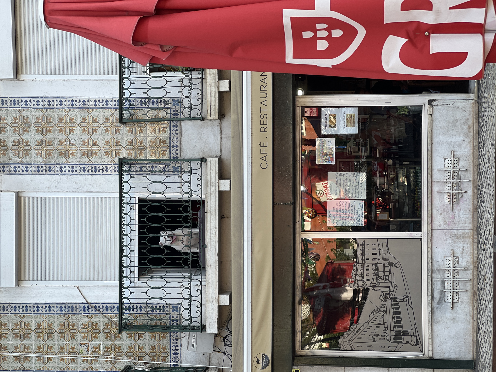 Red-awninged café front on a Lisbon street