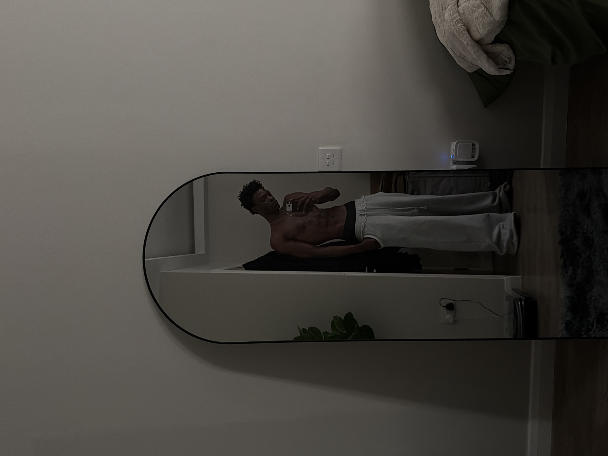 Man takes mirror selfie in London bedroom