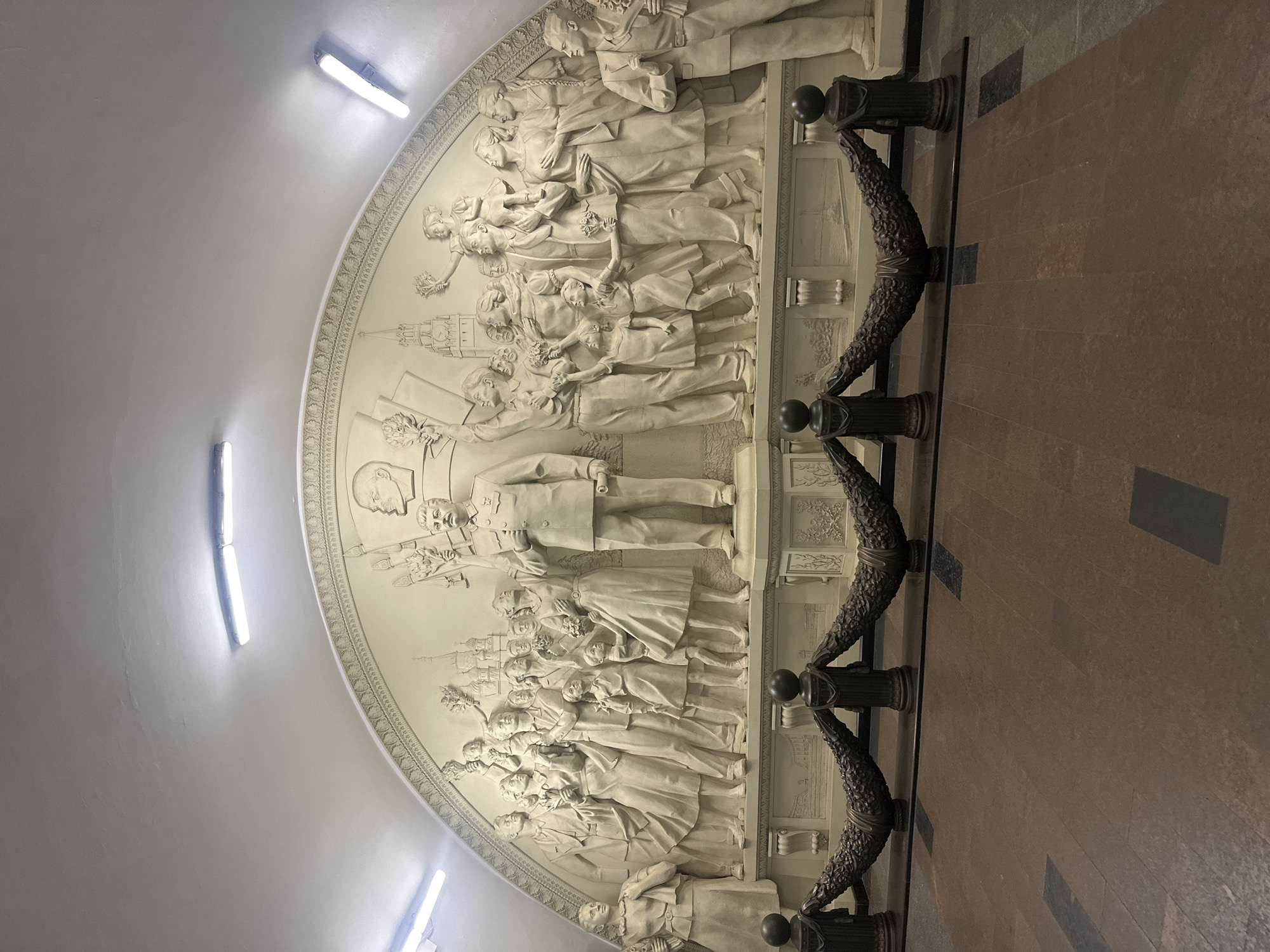 Moscow metro: ornate bas-relief and commuter rush