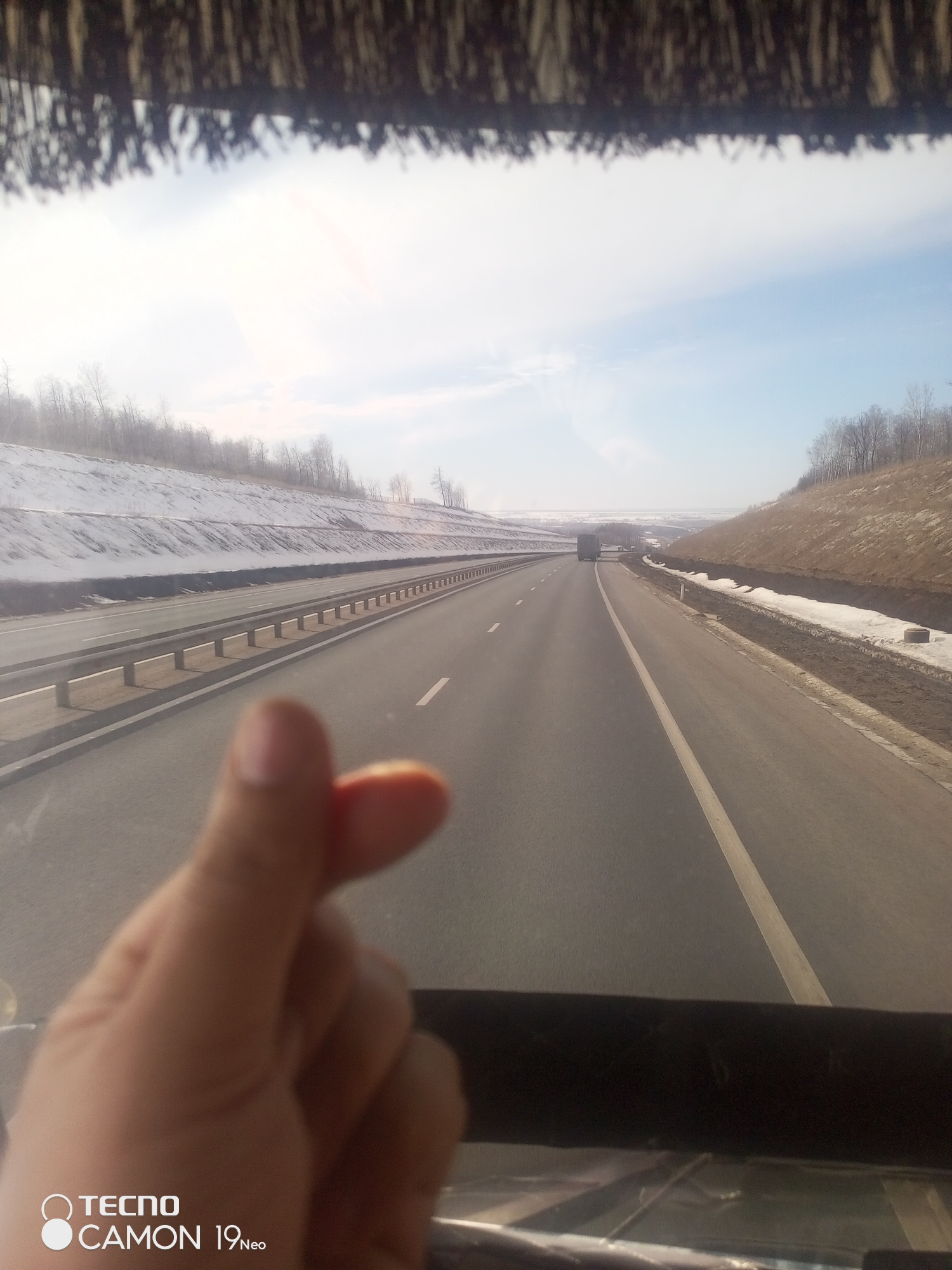 Traveler shares heart gesture on snowy Russian highway