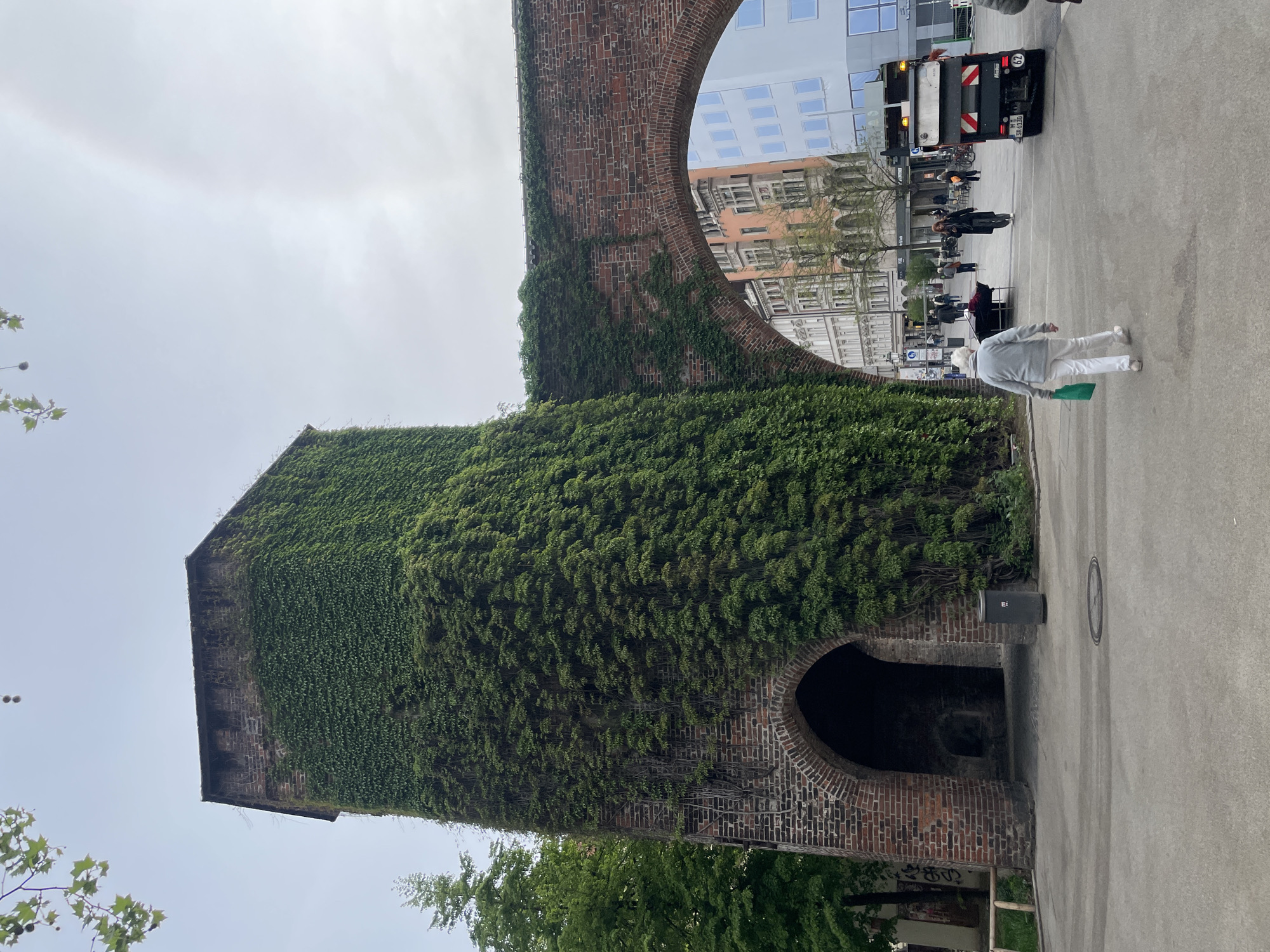 Urban documentation shows historic church tower, modern sculpture
