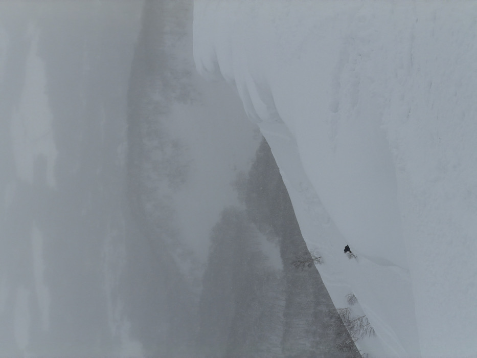 Heavy snowfall obscures lone figure on Niseko mountain slope