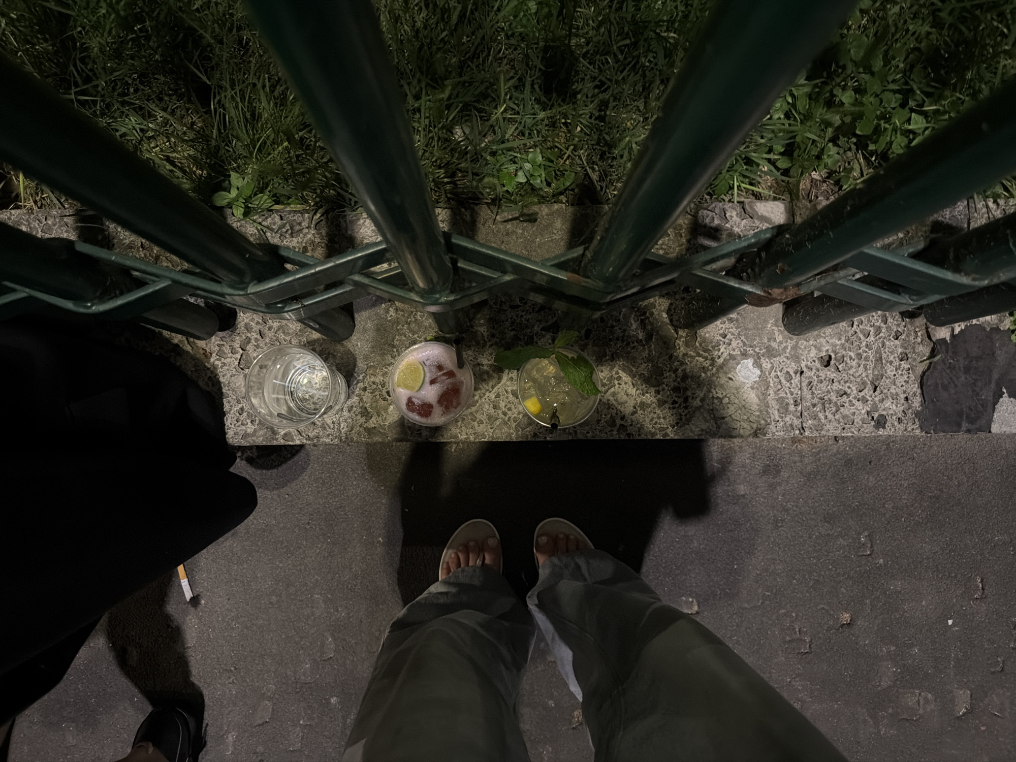 Three drinks left on ground near fence in Milan