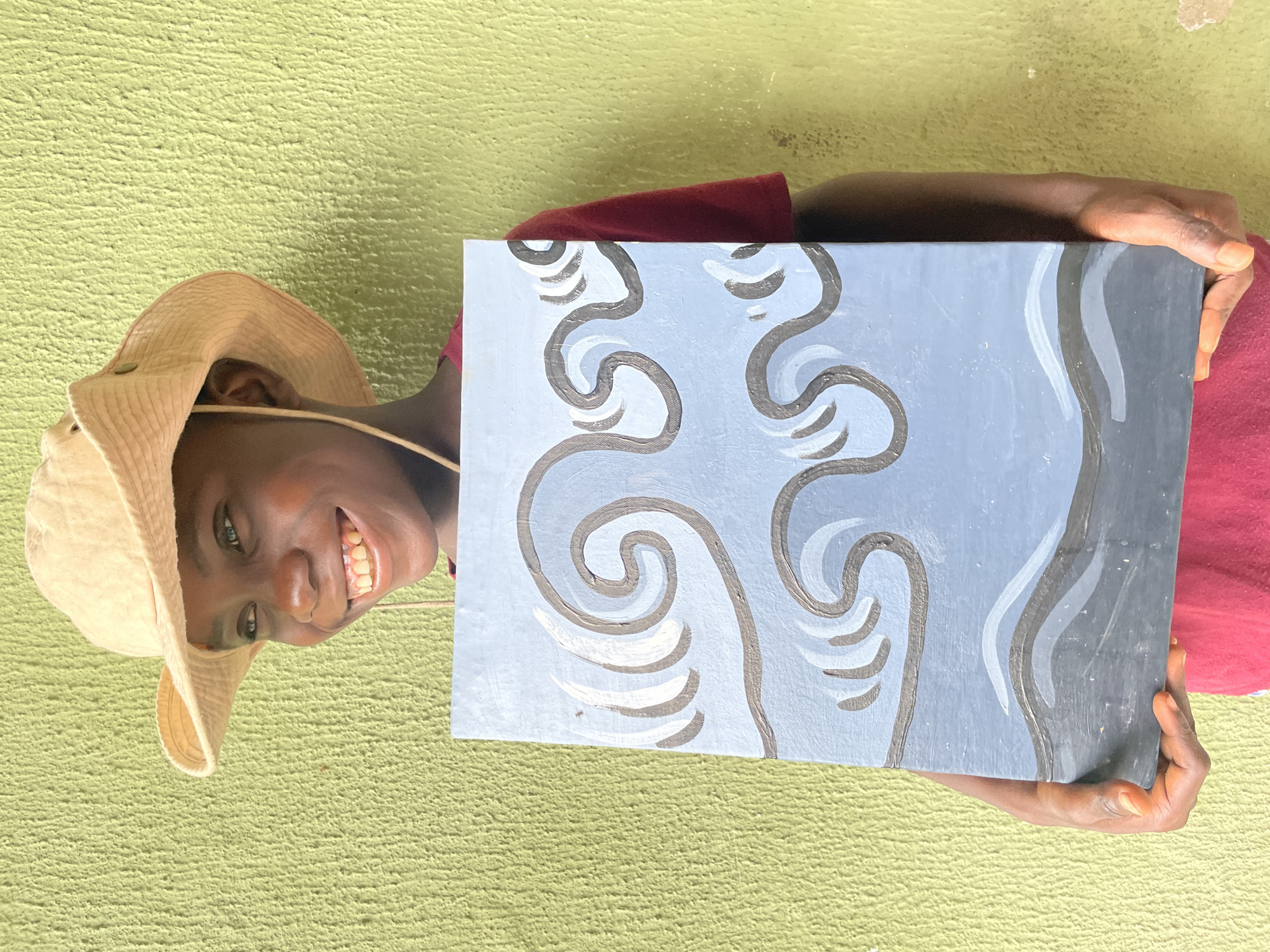 Young artist displays wave paintings on Ado street