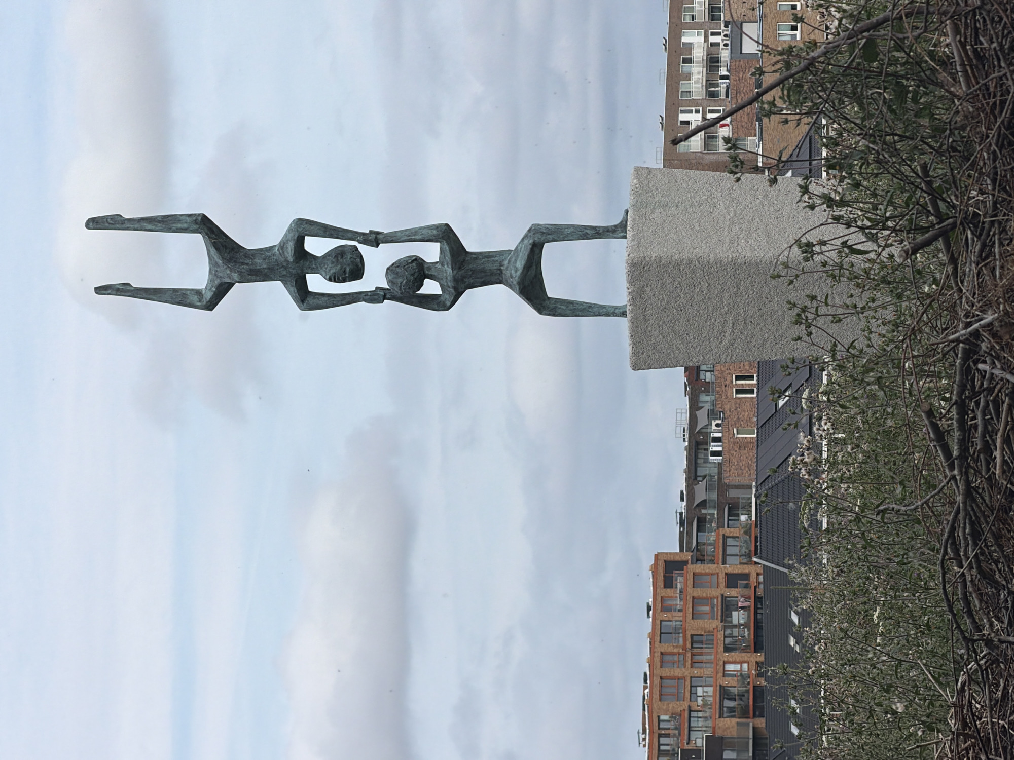 Sculptures and a wooden dock along Rijswijk waterfront