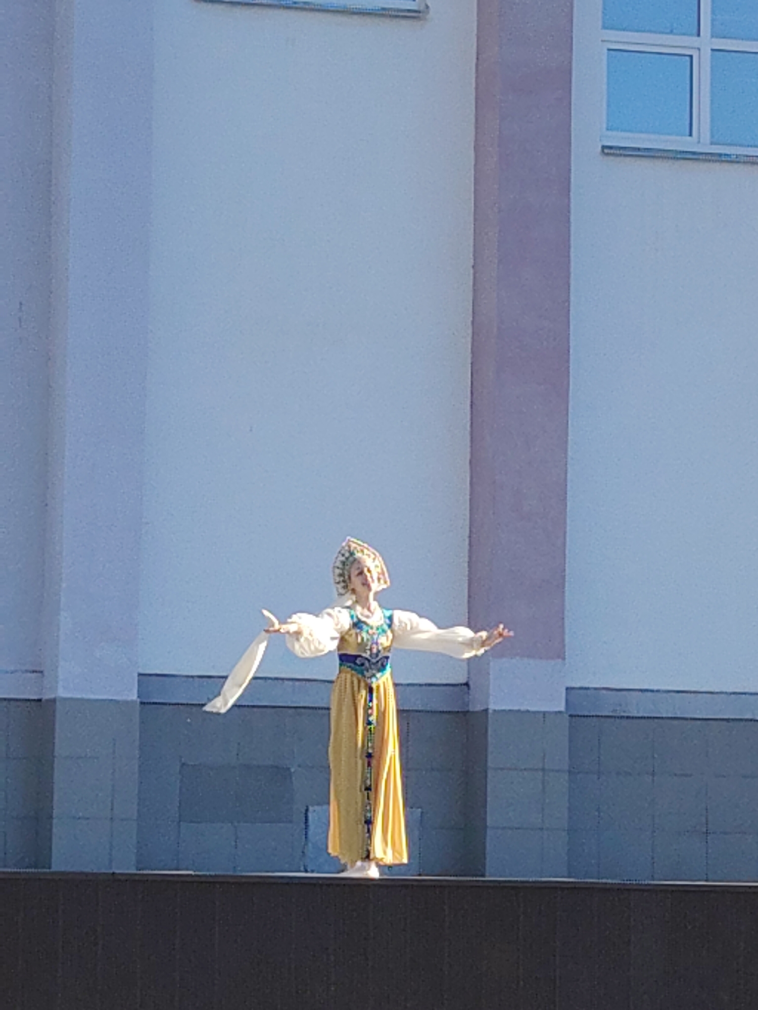 Traditional Russian folk dancers perform outdoor show in urban setting