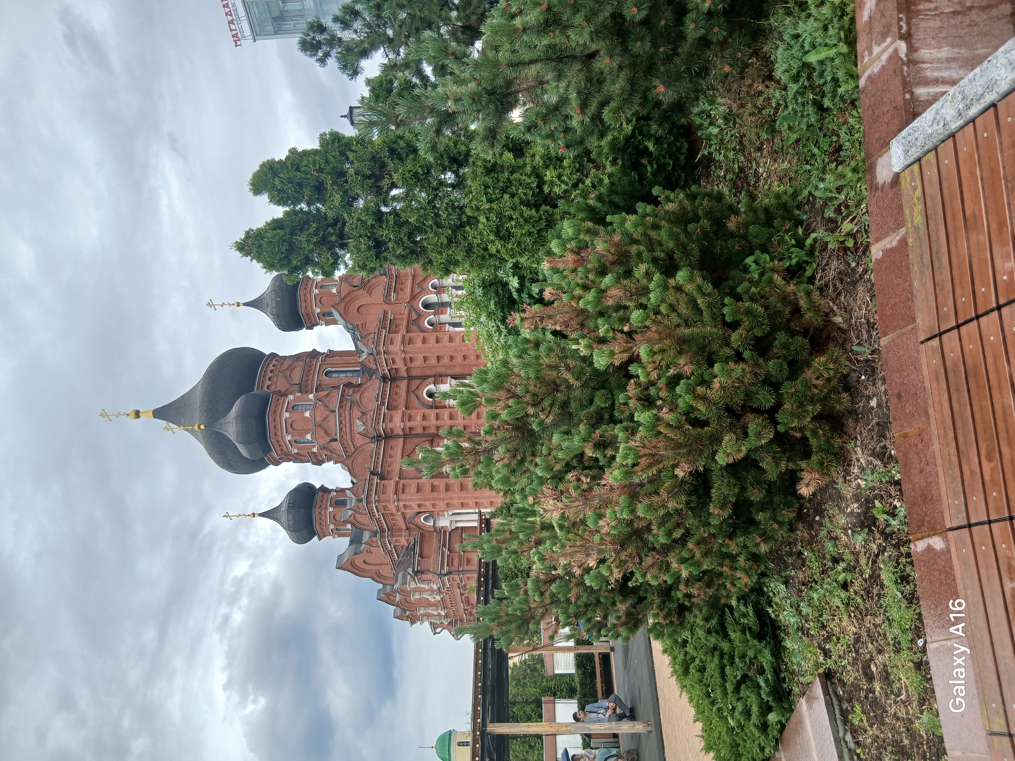 Red brick cathedral, carousel, and fountain plaza in a Russian city