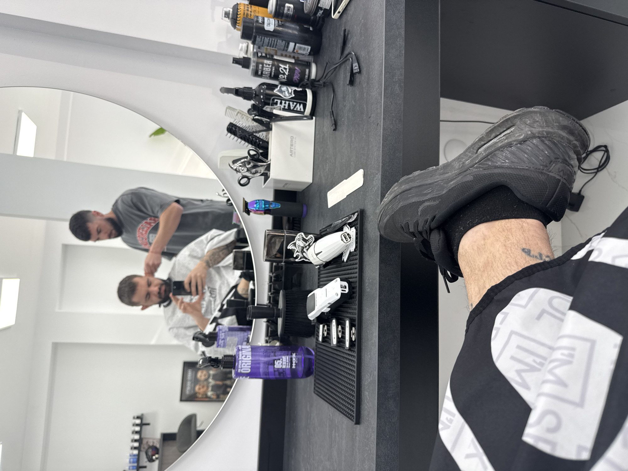 Customer takes selfie during haircut at Bulgarian barbershop