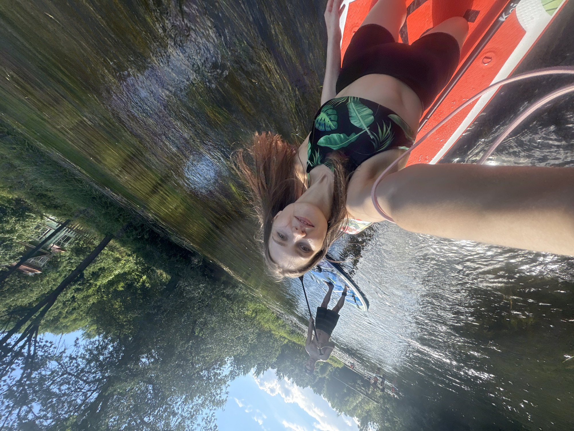 Paddleboard session on a calm Russian river, summer afternoon