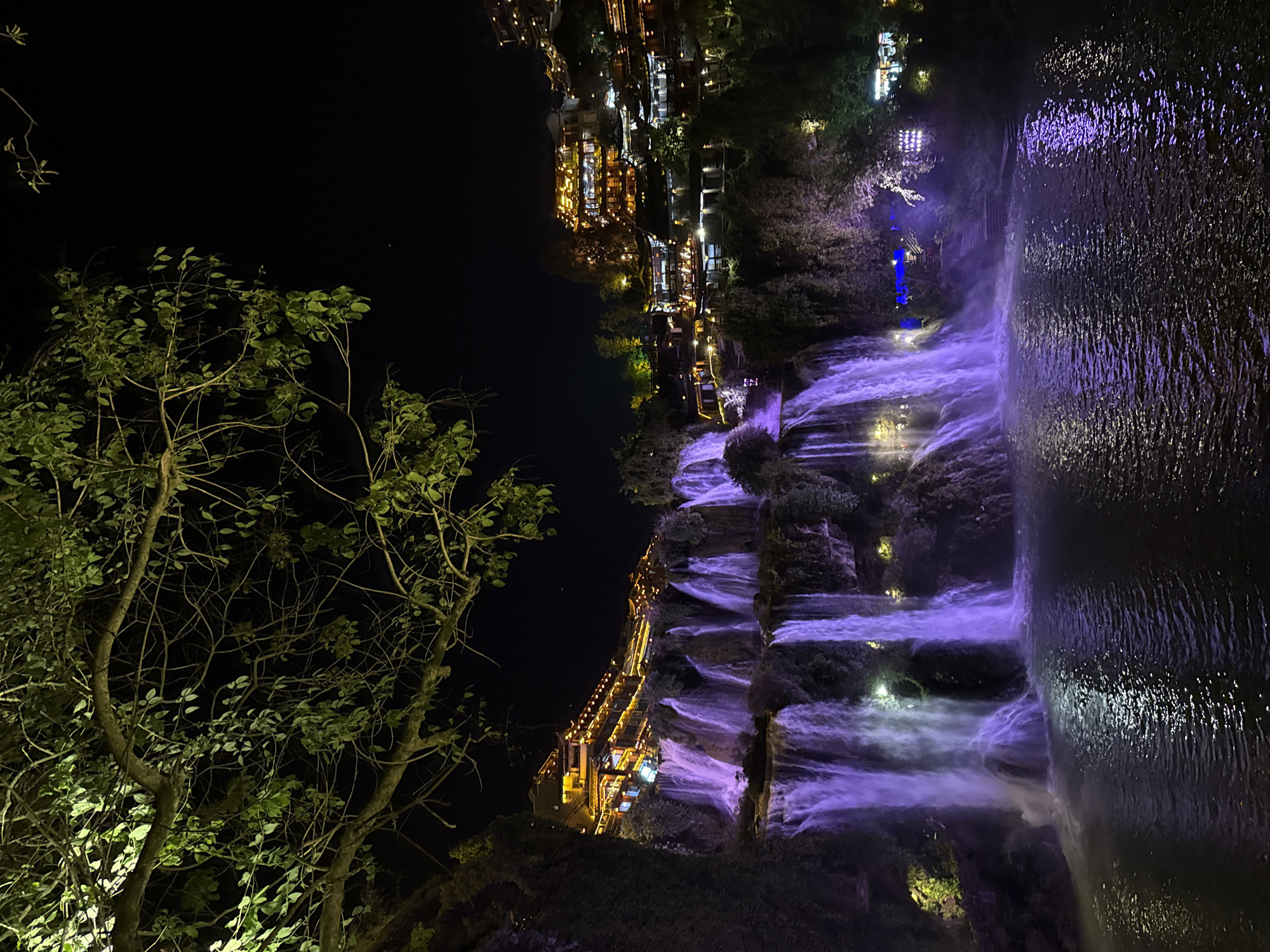 Illuminated waterfalls photographed at night in Furong, China