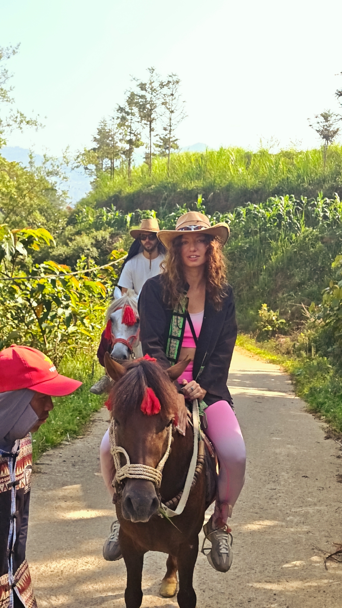 Woman rides horse in cowboy attire in northern Vietnam