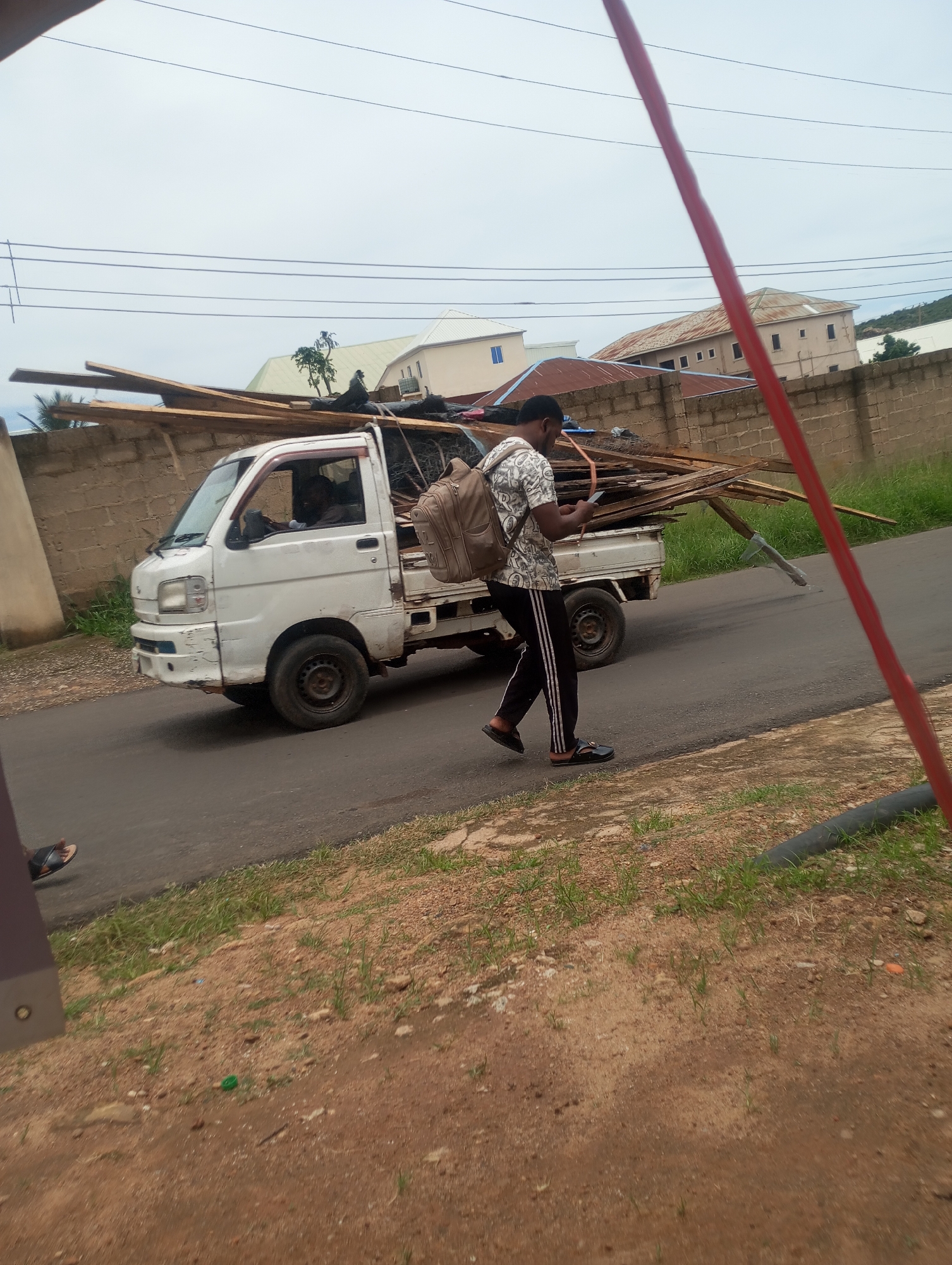 Morning street life on a Jos road, July 2026