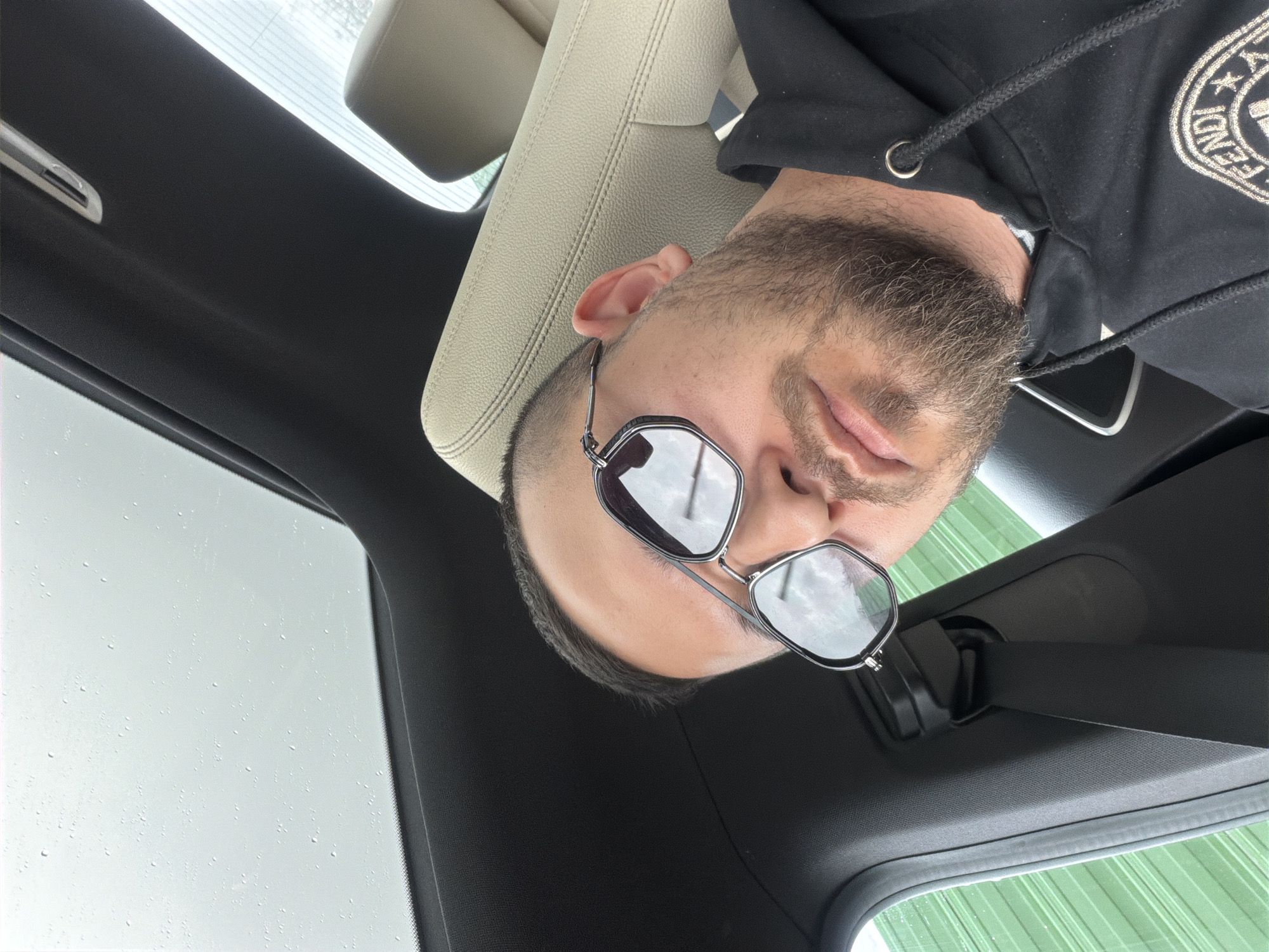 Man in Fendi hoodie spotted in car during rain