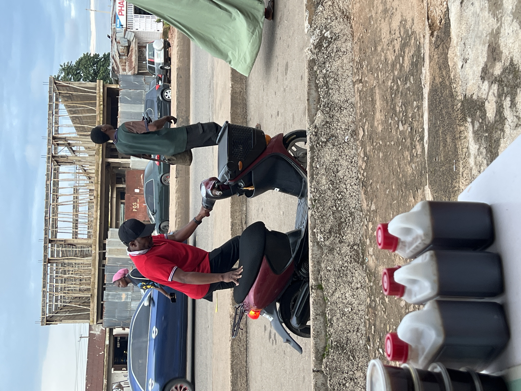 Street activity along a busy urban stretch on an overcast day