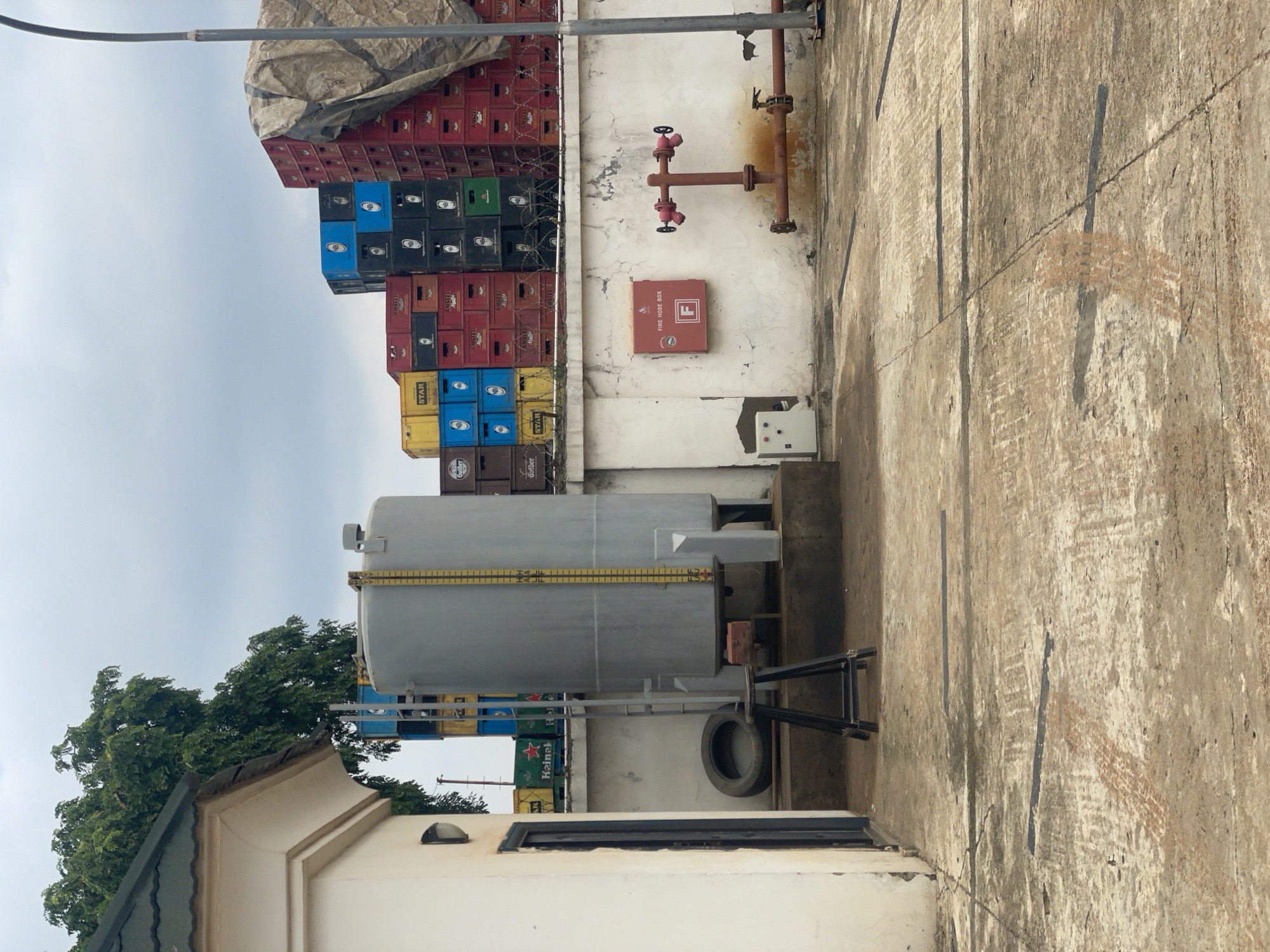 Street-level snapshots from Abuja: vehicles, construction, and a gas cylinder