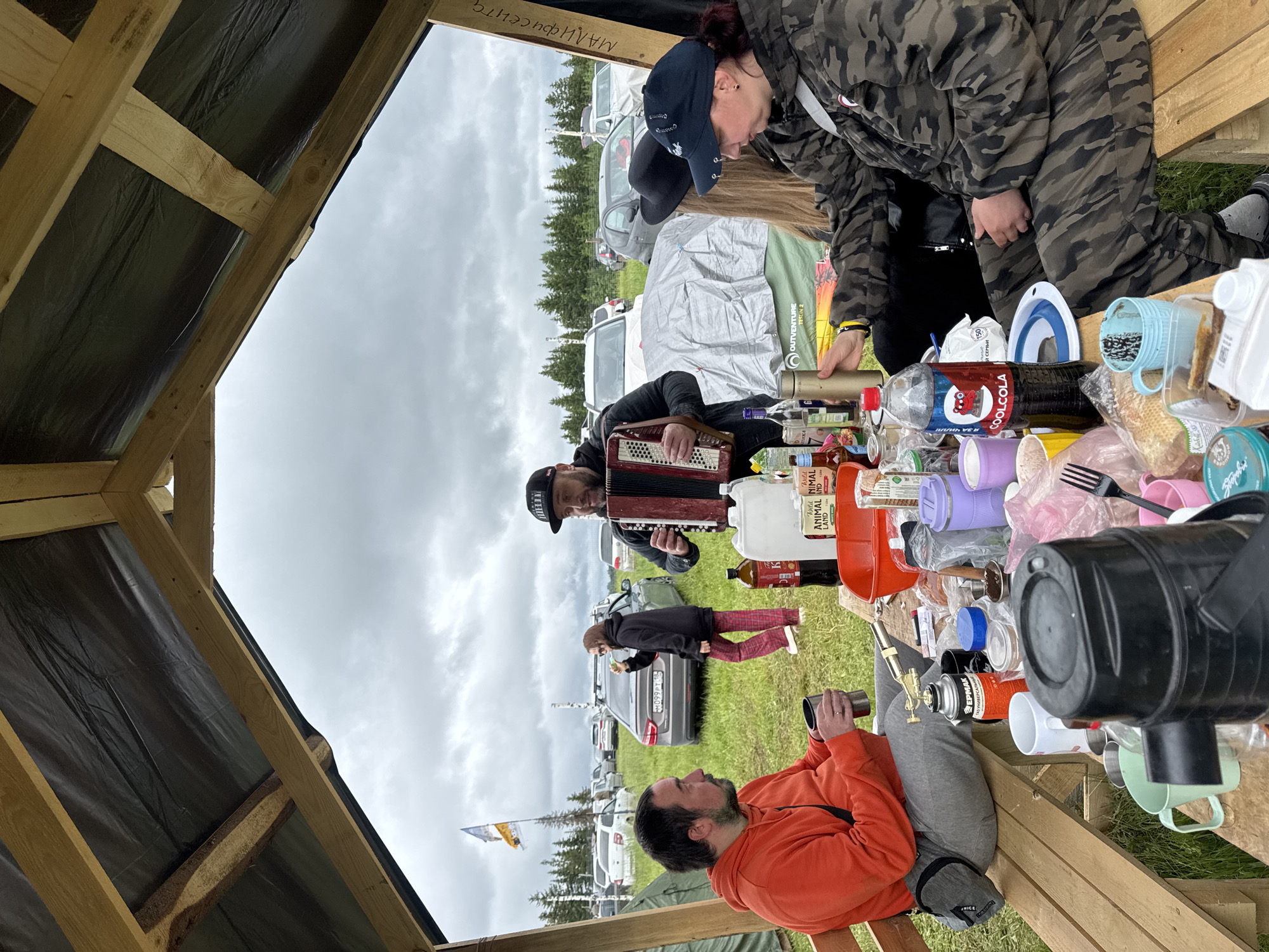 Small group gathers under makeshift shelter in Lipovka, Russia