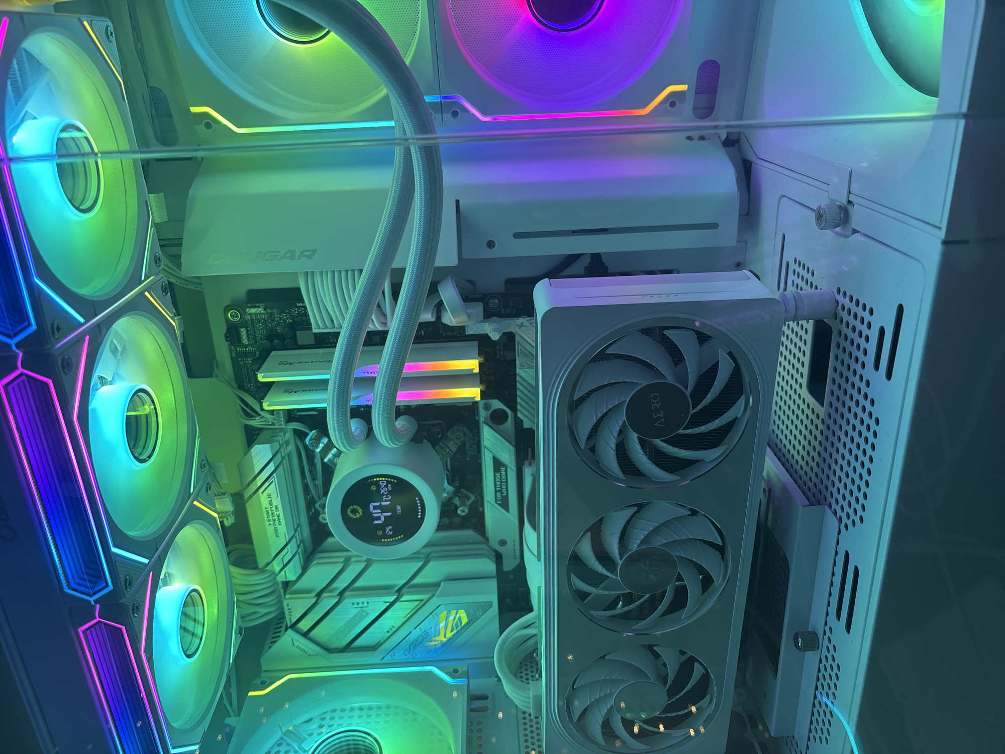 White RGB gaming PC build with matching peripherals and desk decor