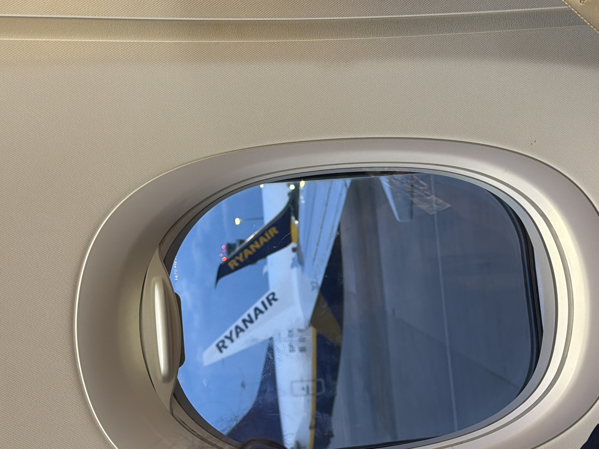 Passenger documents airplane window view over Sofia, Bulgaria