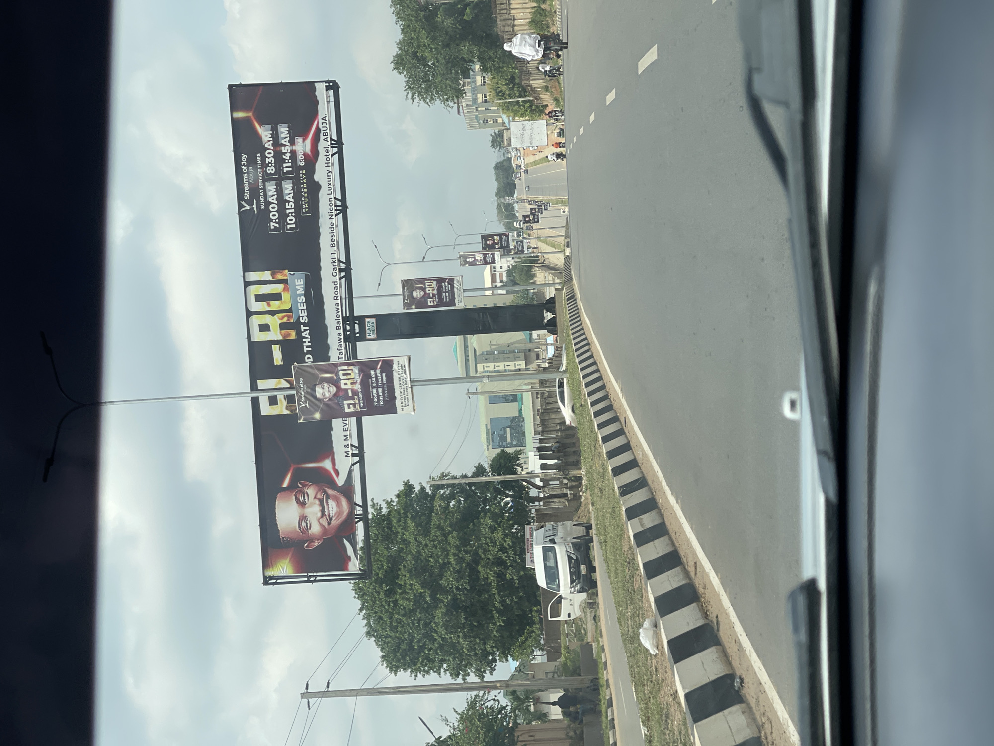 Traveler documents everyday Abuja scenes: billboards, buildings, construction