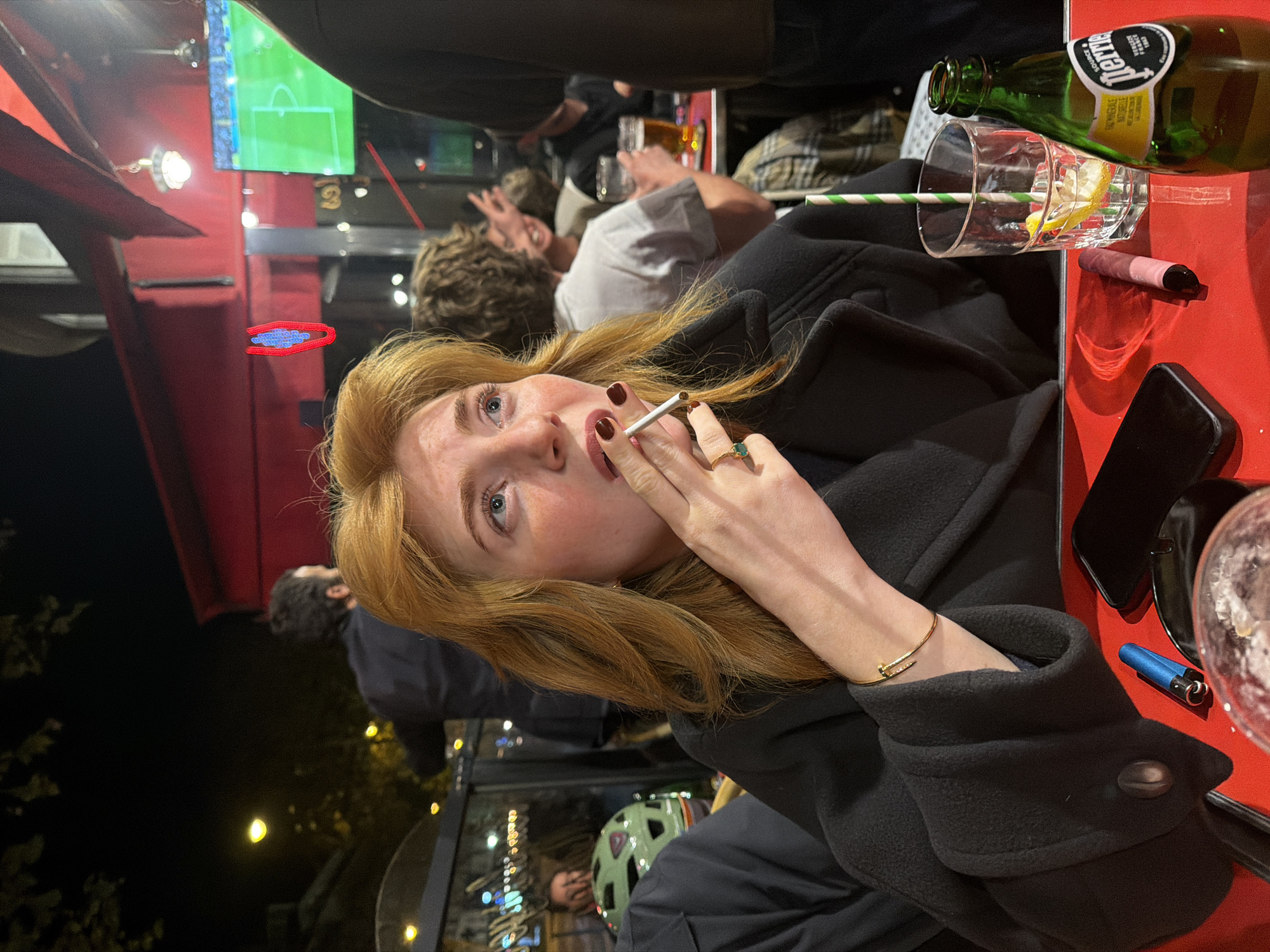 Woman sits at outdoor Parisian café table