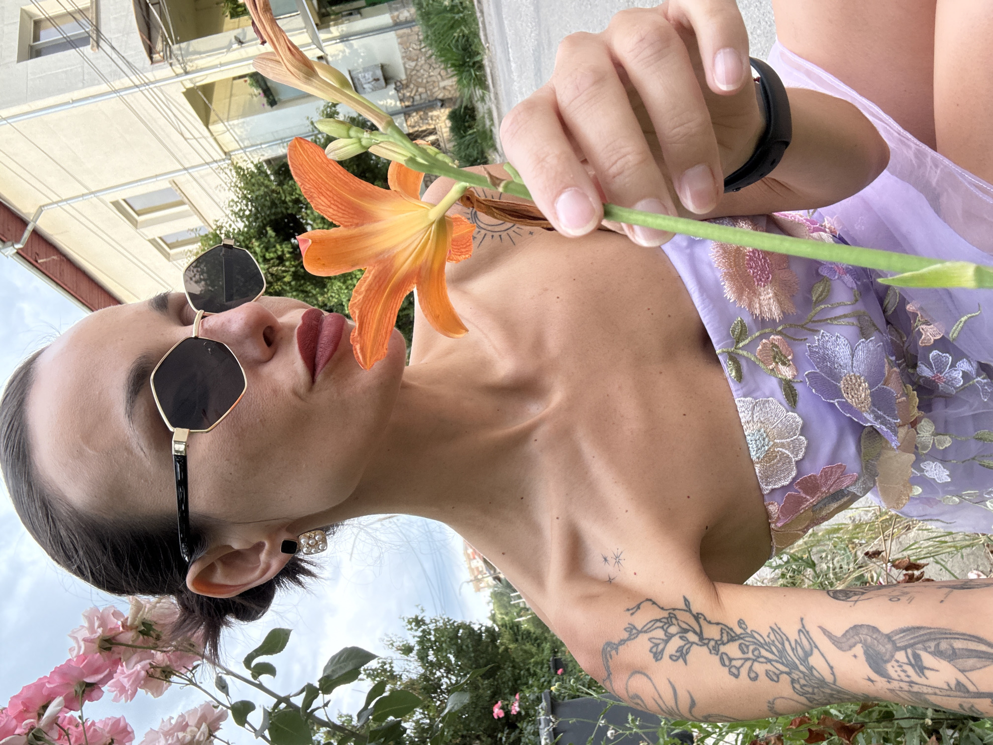 Woman in purple dress photographed with flowers in Pleven