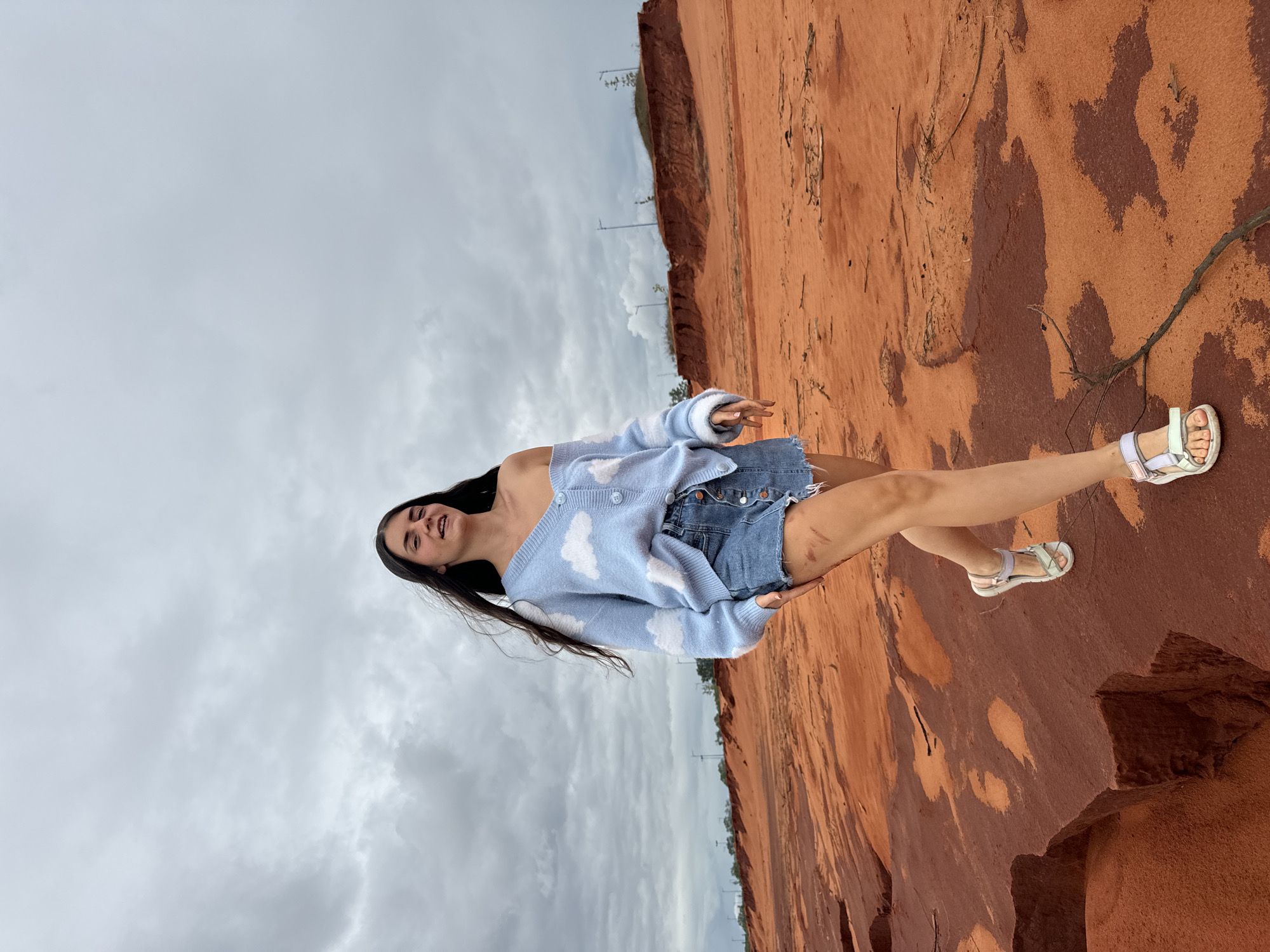 Tourist poses at Fairy Stream red rocks, Mui Ne