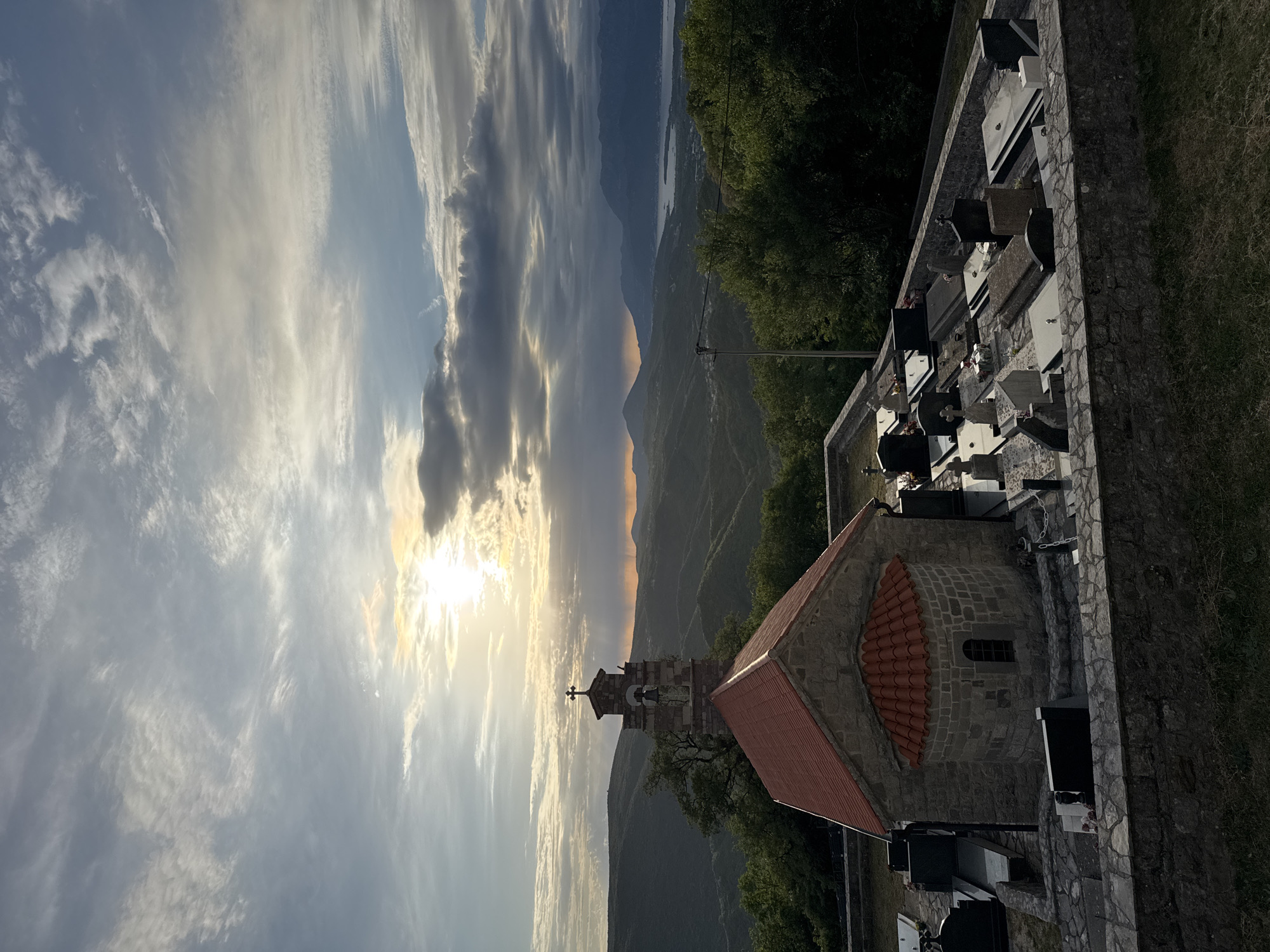 Stone church and bell tower observed at sunset in Bratešići