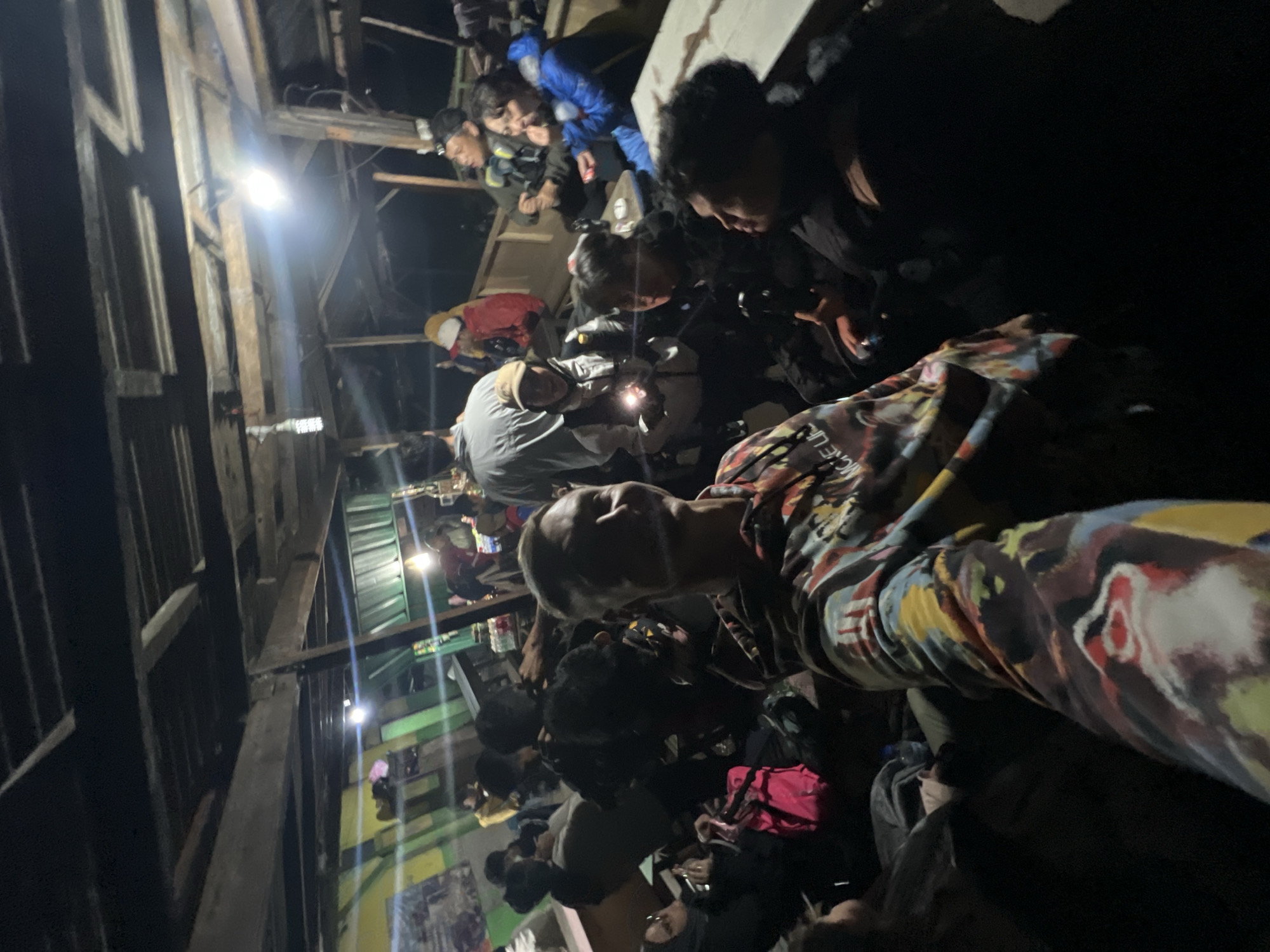 Evening gathering in basic shelter documented in Indonesia