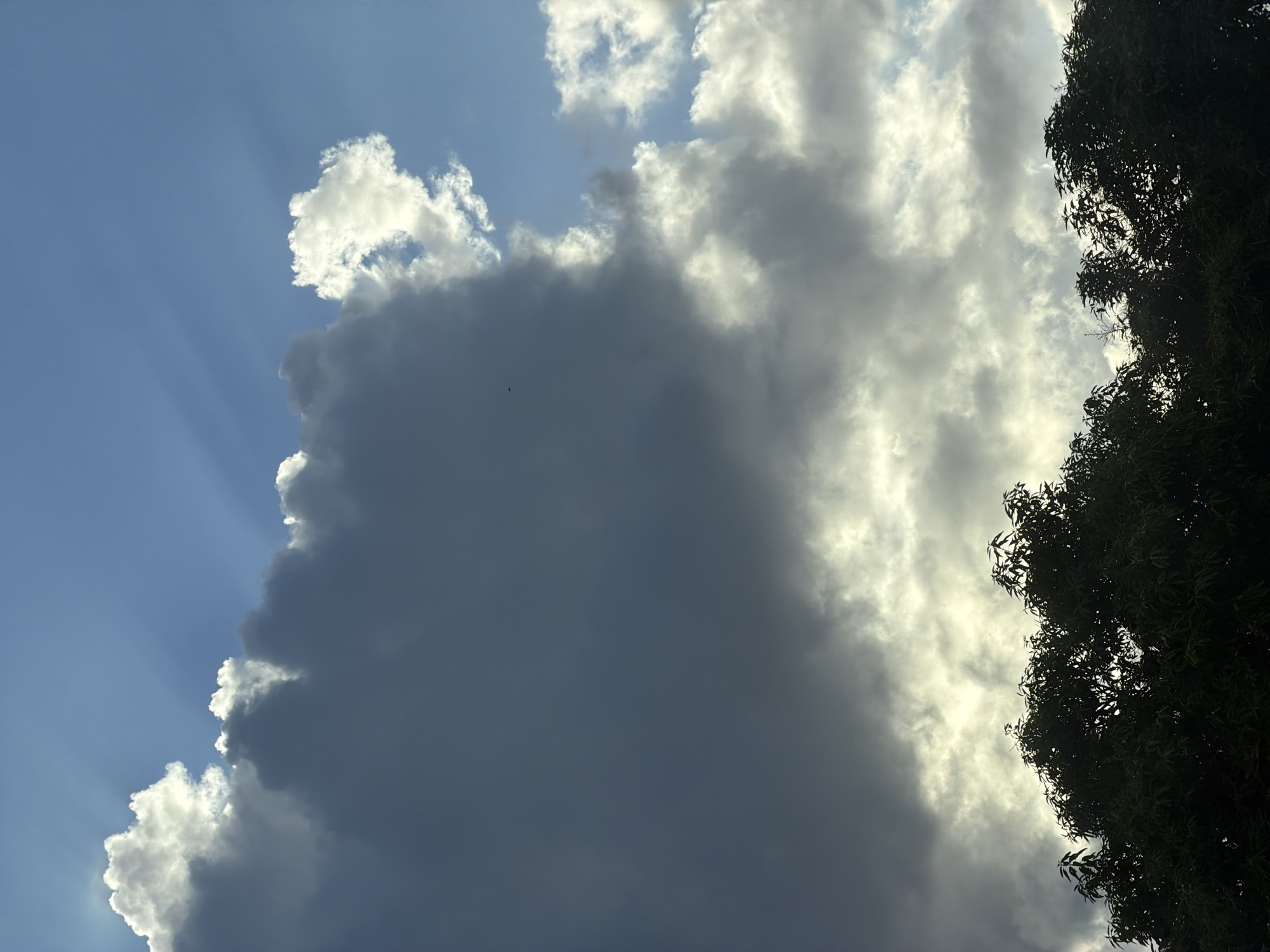 Dramatic sunbeams photographed through clouds in North Kuta, Indonesia